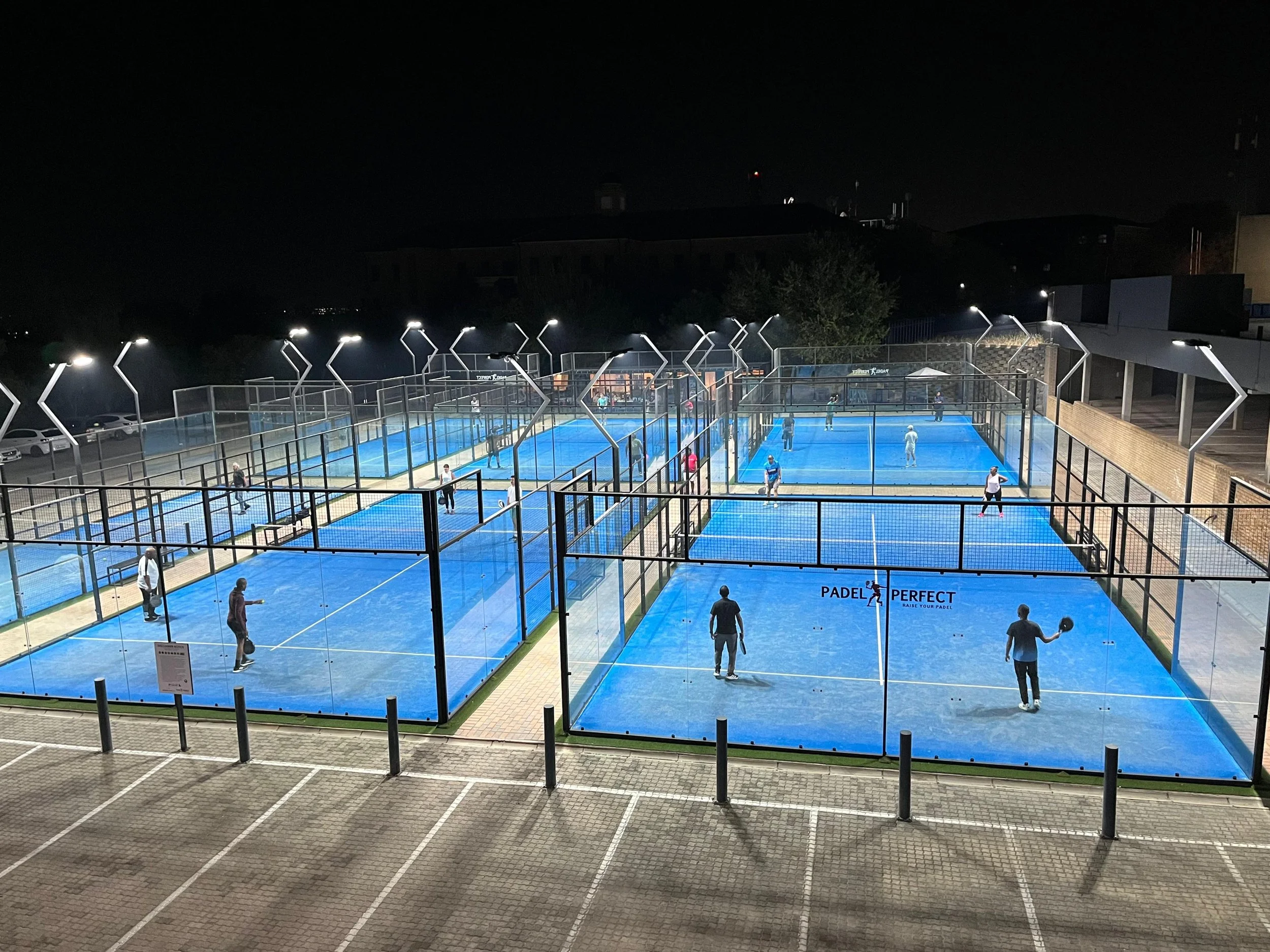 Multiple padel courts at Morning Glen at Night taken with a  drone.