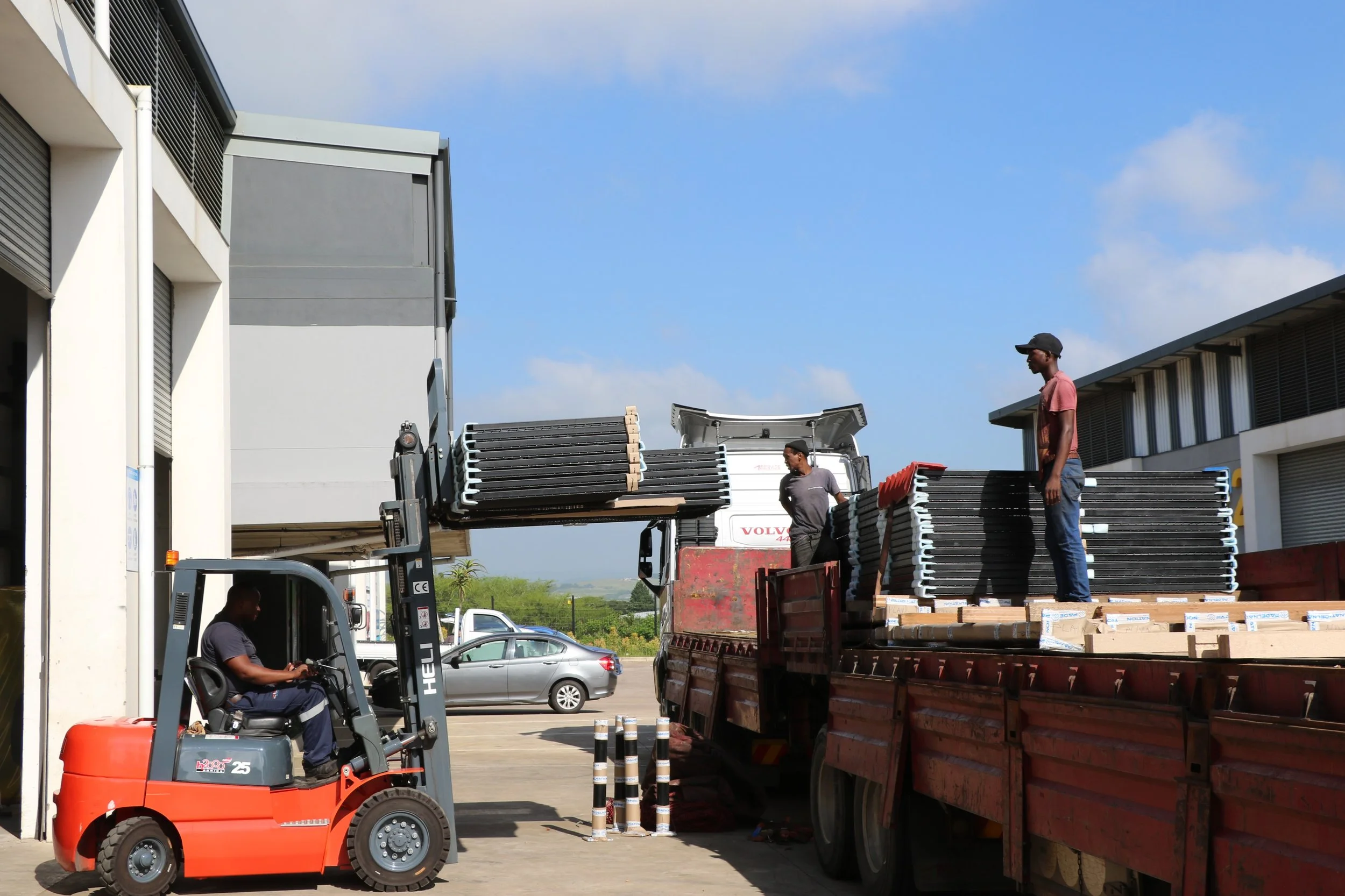 Workers loading padel courts onto the delivery track.