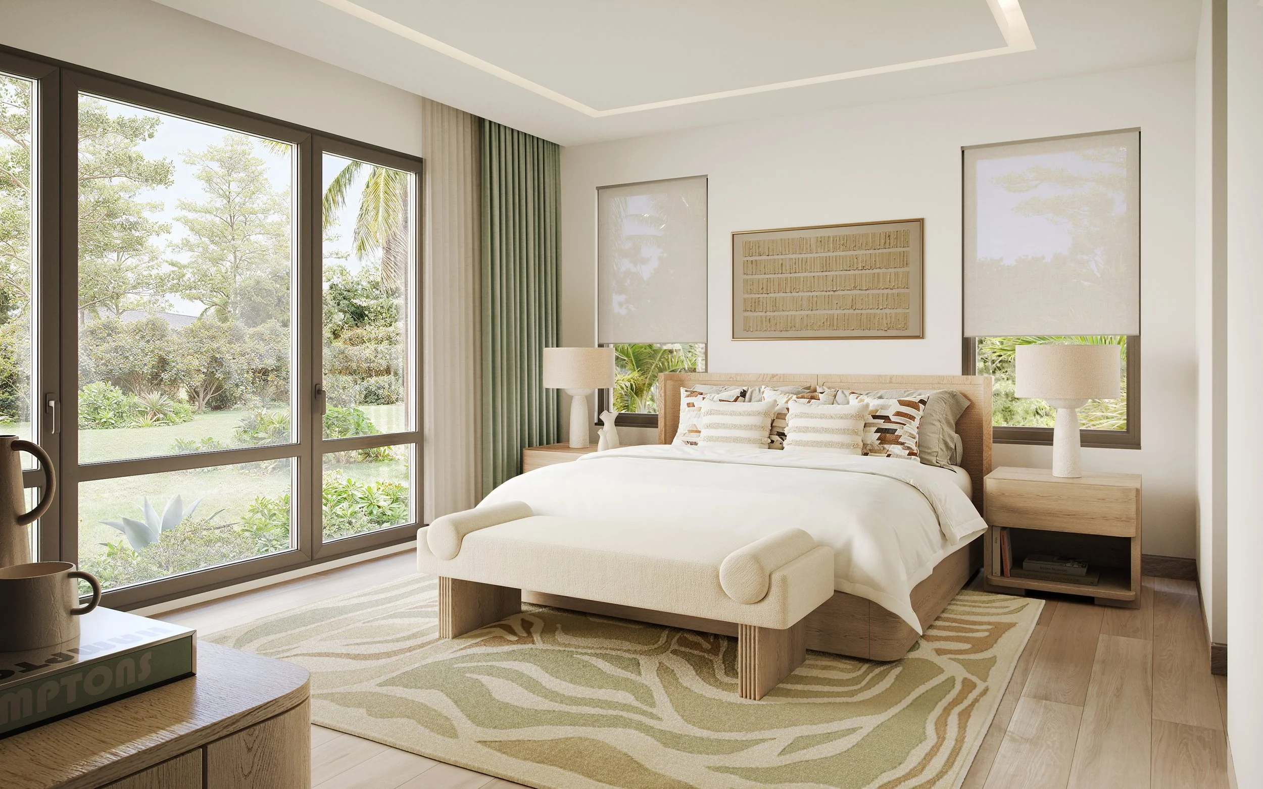 A bright bedroom with large sliding glass doors overlooking a lush green garden. The room features a bed with decorative pillows, two bedside tables with lamps, a framed artwork on the wall, and a patterned rug on light wood flooring.