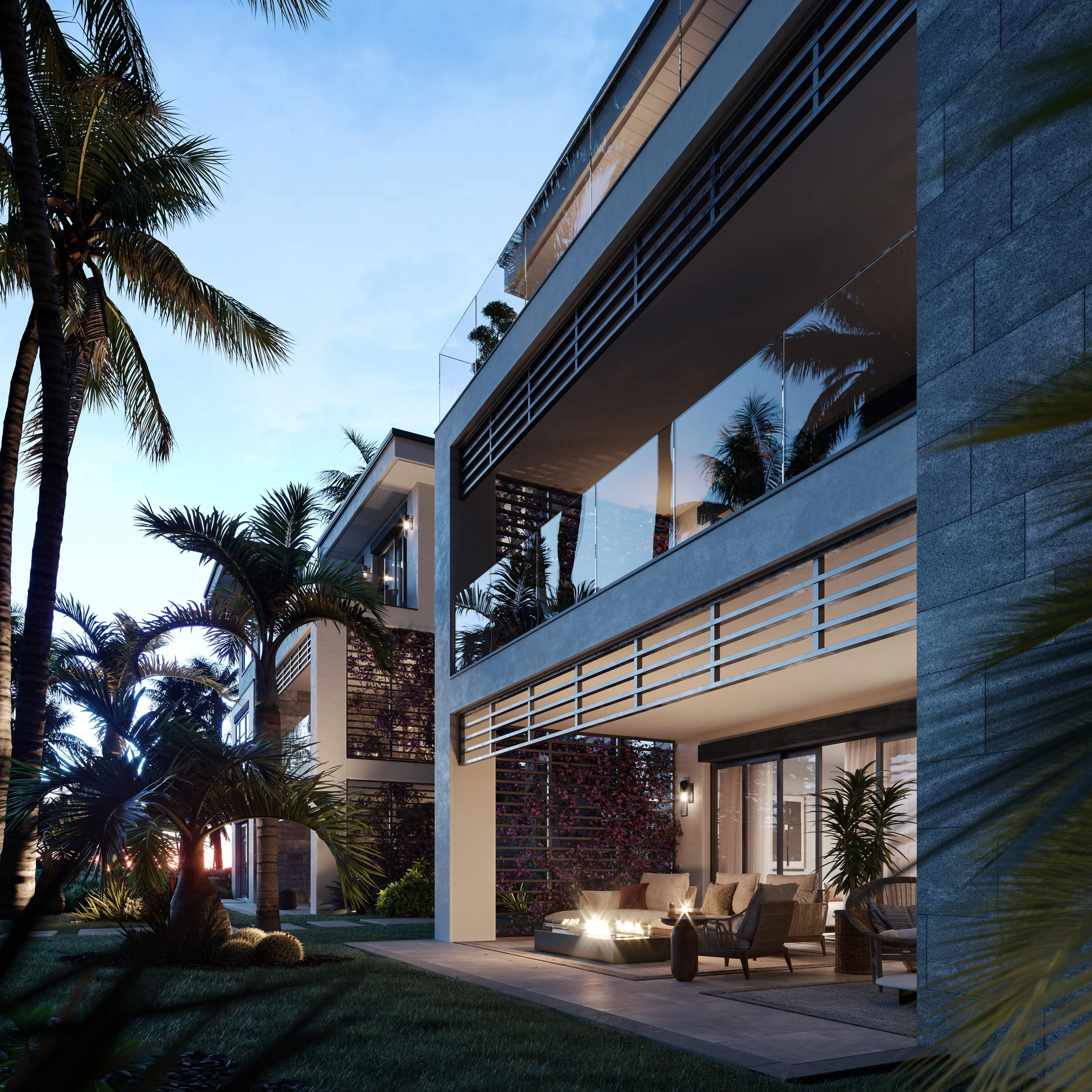 Modern multi-story building with glass balconies surrounded by palm trees, illuminated by outdoor lighting at dusk.
