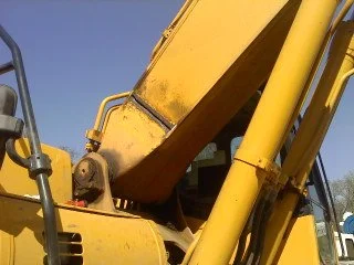 Close-up of a yellow construction excavator's arm and bucket.