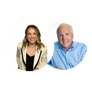 A young woman with blonde hair and a beige blazer smiling next to an older man with white hair in a blue shirt, both sitting at a table with a white background.