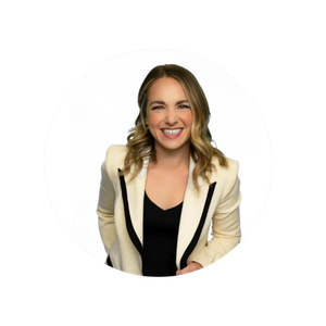 Smiling woman with shoulder-length hair, wearing a white blazer with black accents over a black top, against a white background.