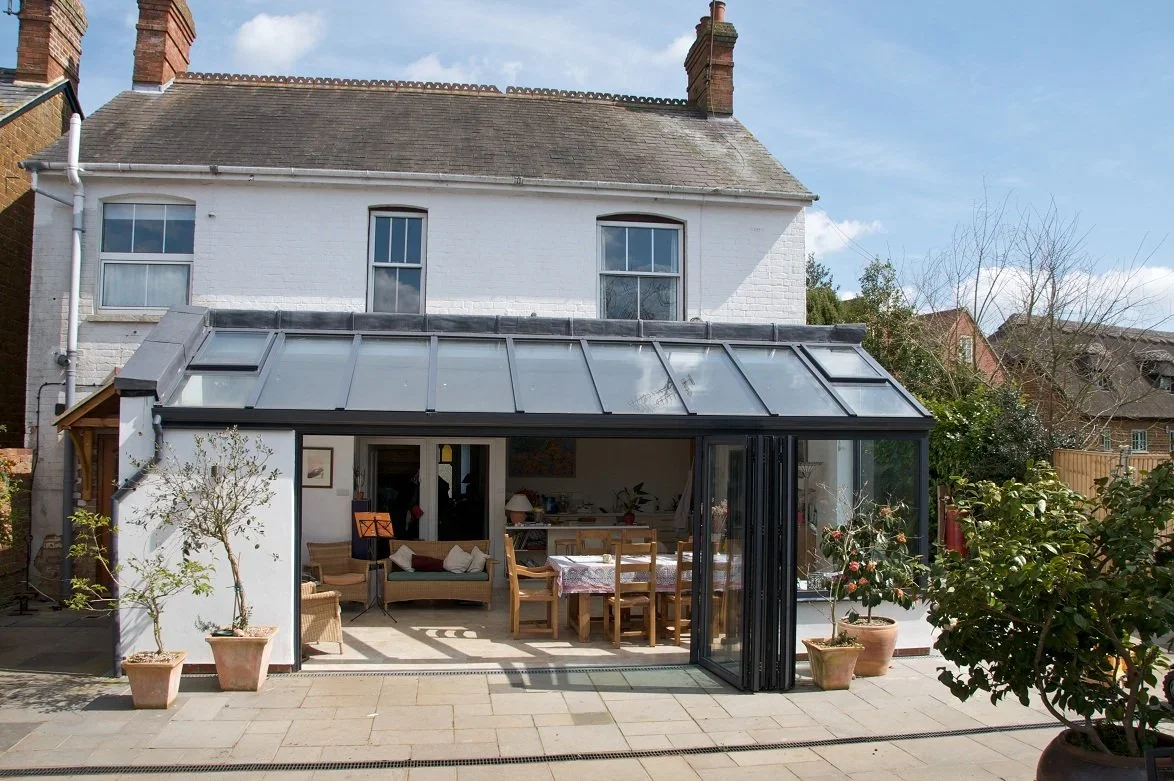 A light-filled hardwood sun room extension integrated with the historic charm of a Wedmore village property.