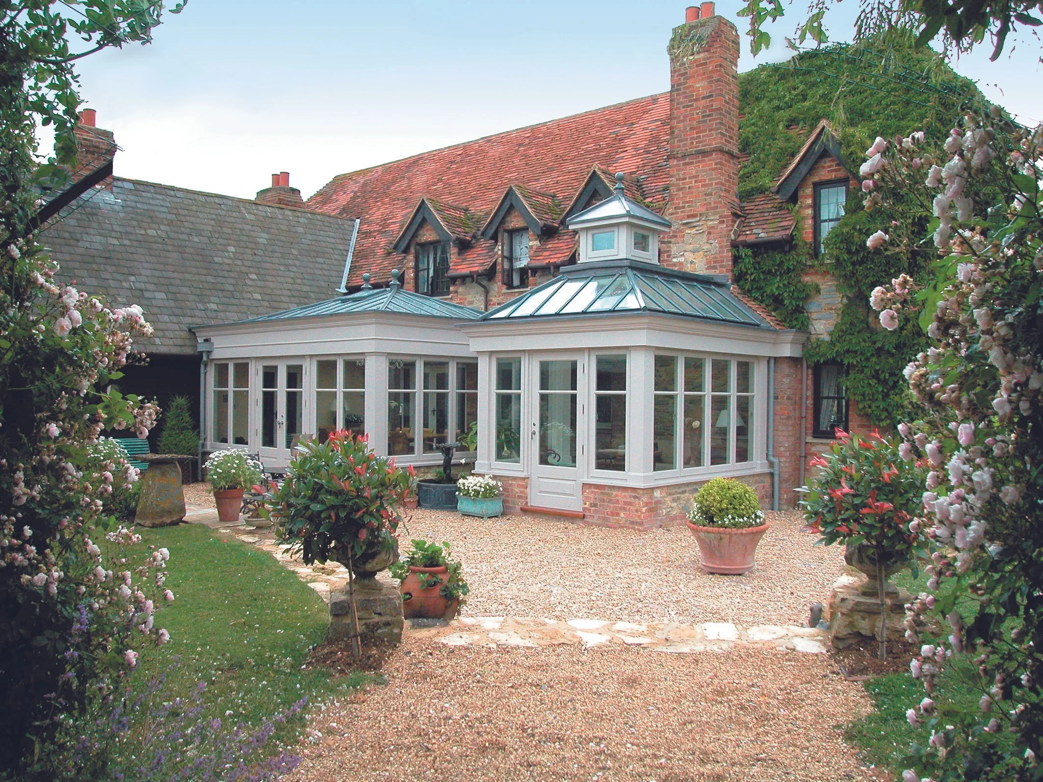 High-performance sapele hardwood timber garden room extension designed for year-round use in the Cotswolds.