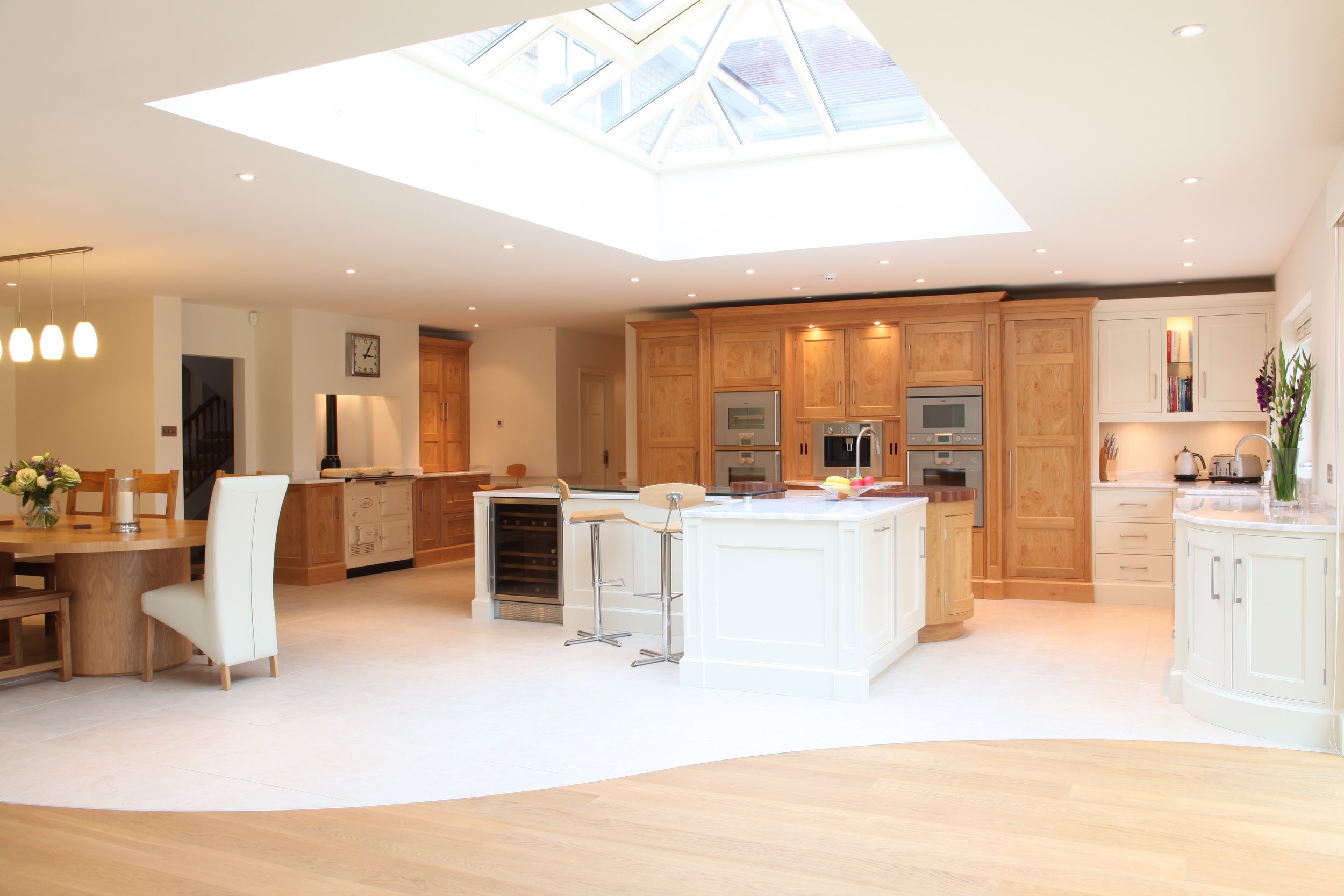 Open-plan kitchen and dining extension with roof glazing bringing light into the existing house