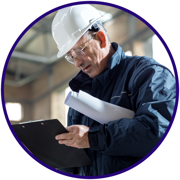 Construction site manager reviewing environmental compliance documents on site