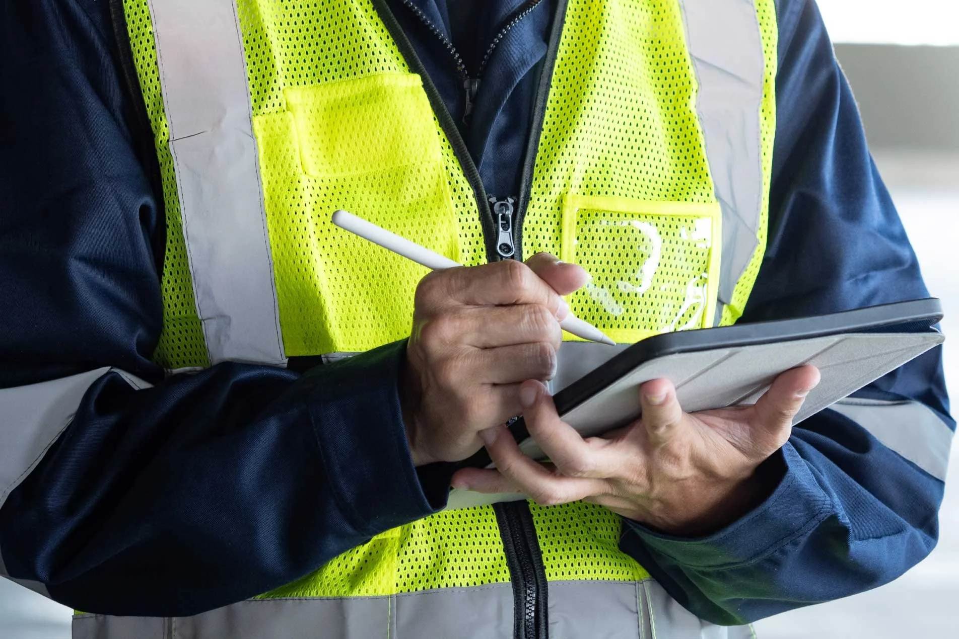 Construction site manager writing notes during site inspection