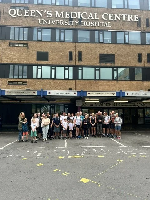 Group of people standing in front of Queen's Medical Centre hospital entrance