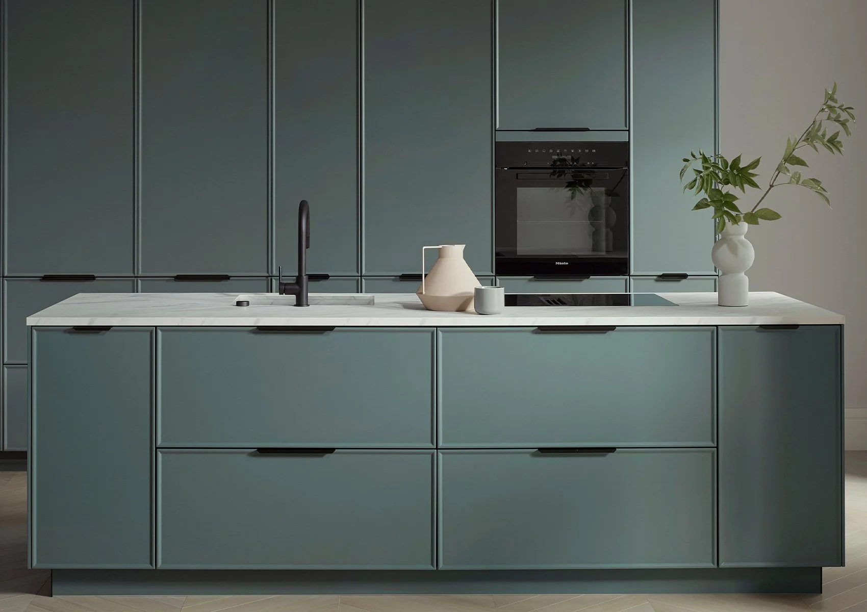 Modern kitchen with teal cabinets, white marble countertop, black faucet, ceramic pitcher, small cup, black oven, built-in stovetop, and a white vase with green leafy branches.