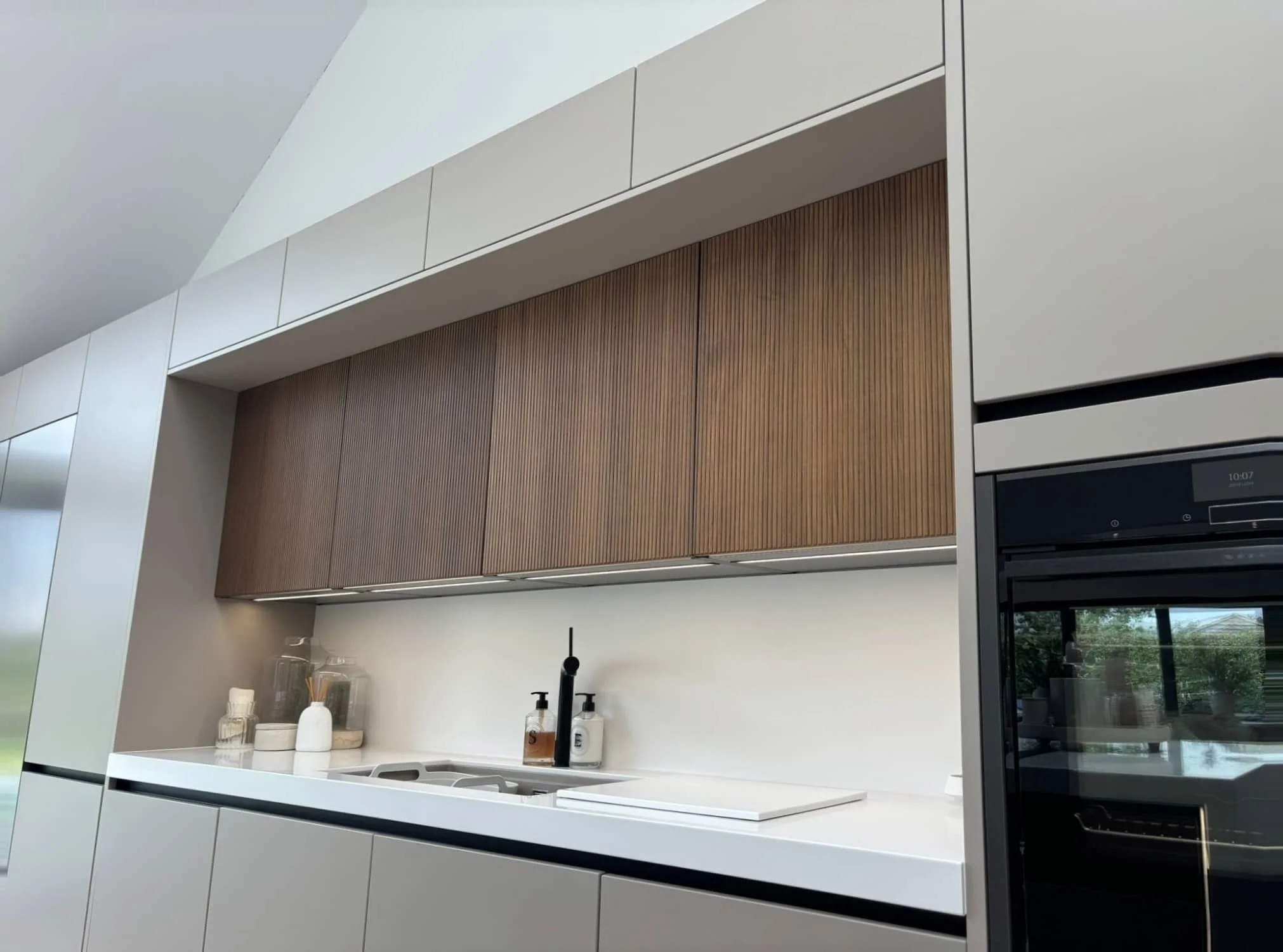 Modern Häcker Systemat kitchen in fluted walnut with brushed bronze island -IMG_5146_perspective_corrected.jpeg