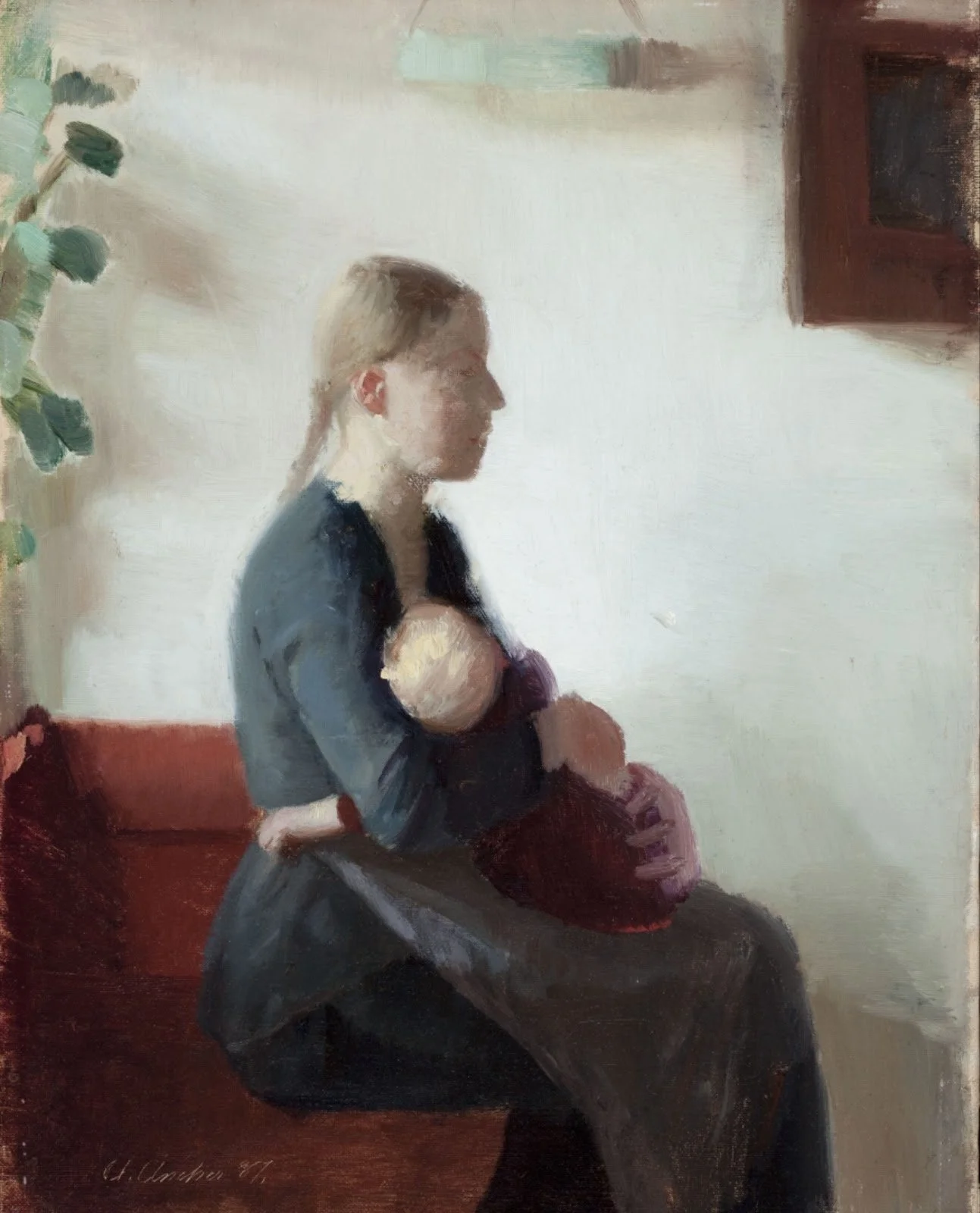 A woman with blonde hair tied in a braid, wearing a dark dress with a grey shawl, seated on a red bench next to a green plant with broad leaves, in a room with white walls and a brown frame on the wall.