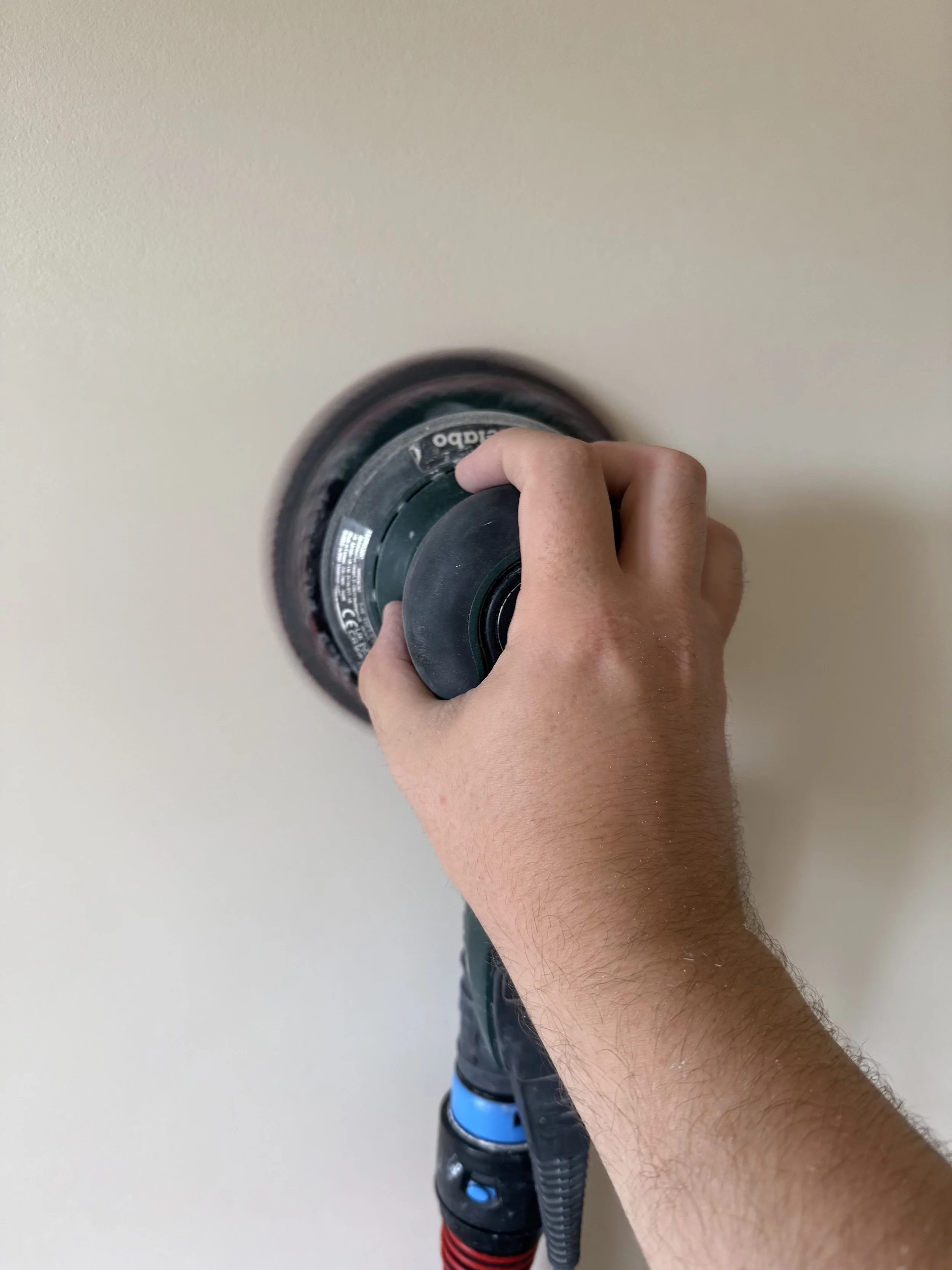 Dustless sanding power sander being used on wall in Chesterfield