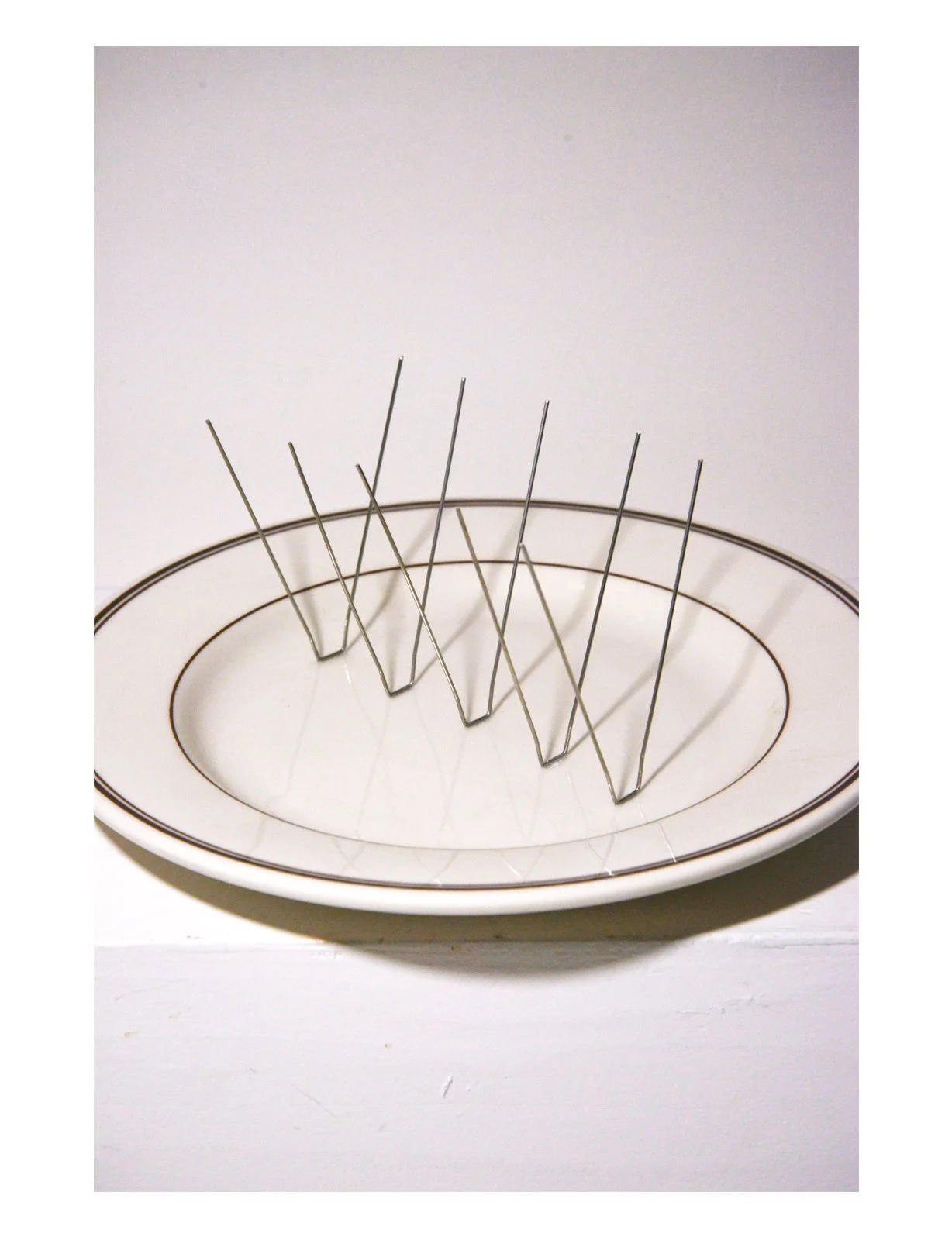 Control, ceramic dinner plate, metal spikes, 11 in x 9.9 in