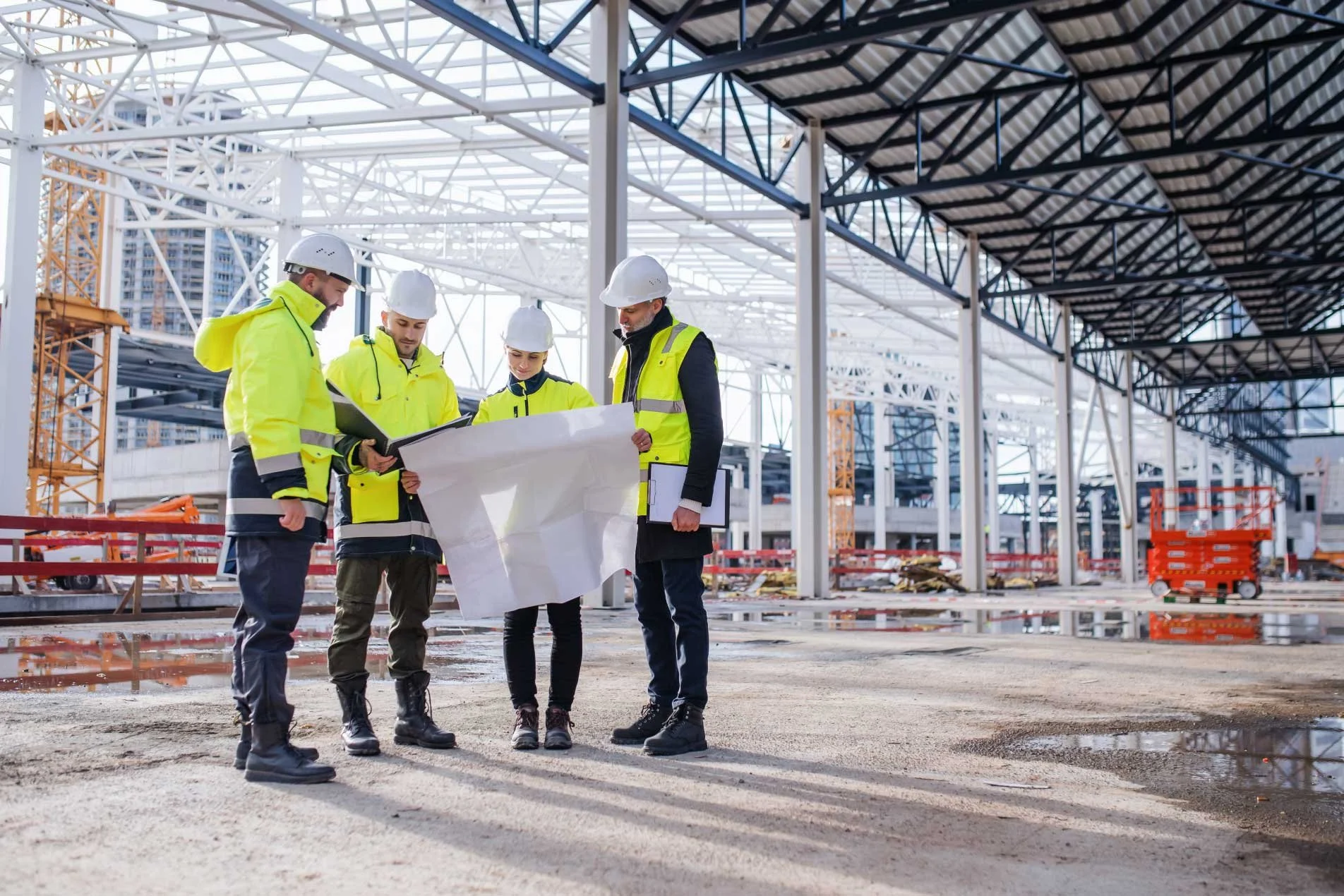 Construction manager and site supervisors discussing work on a construction site.