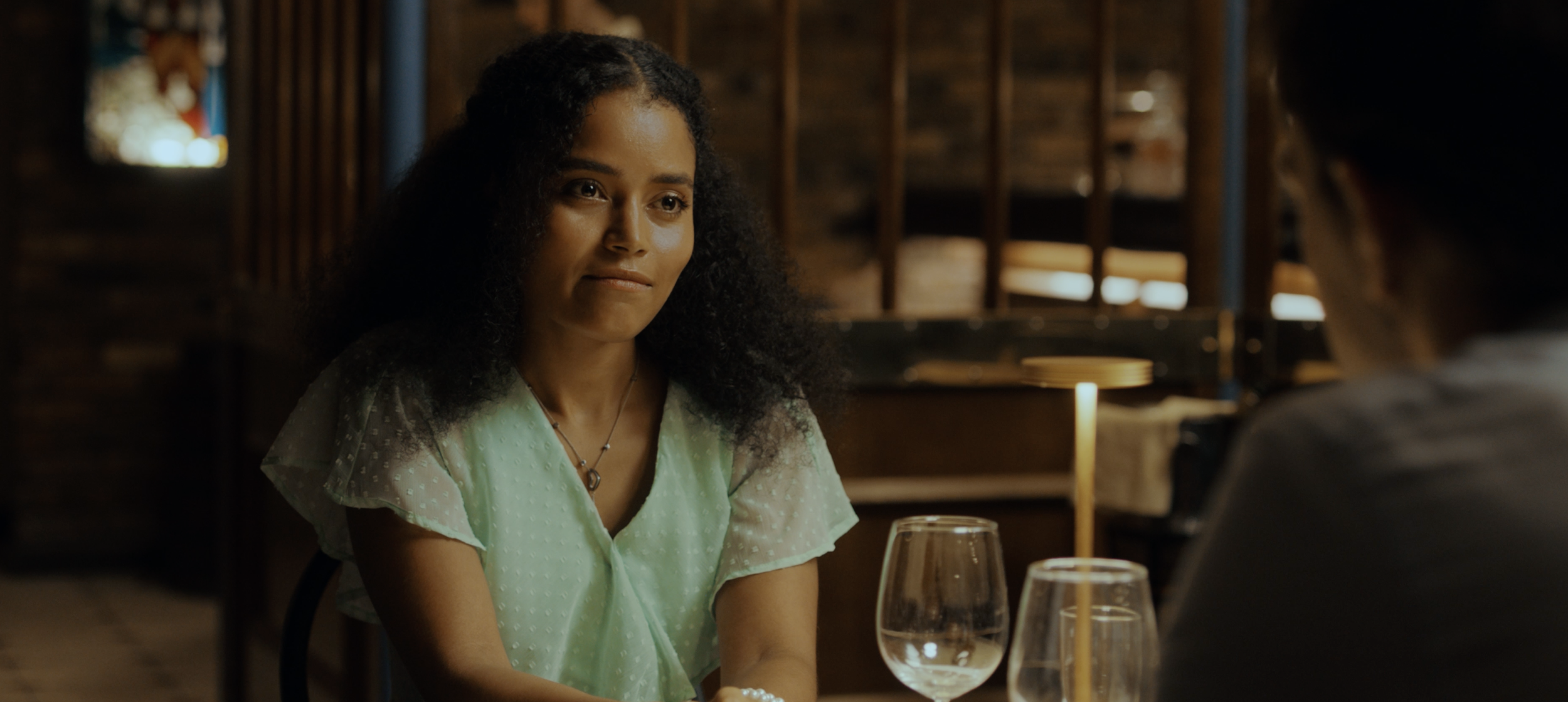 Copy of Lara - at table looking at Mike.png