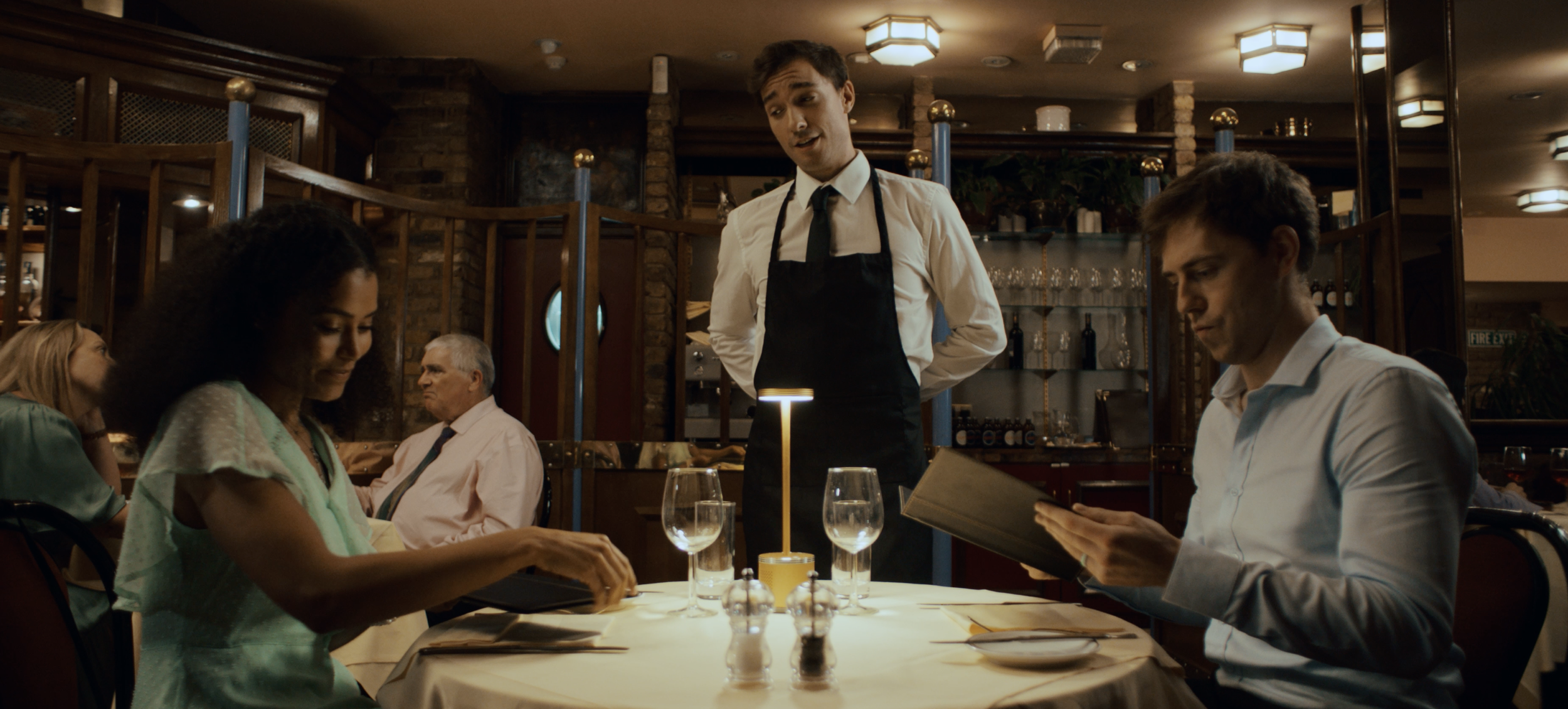 Copy of Wide shot at table, Lara, Mike & Spanish Waiter.png