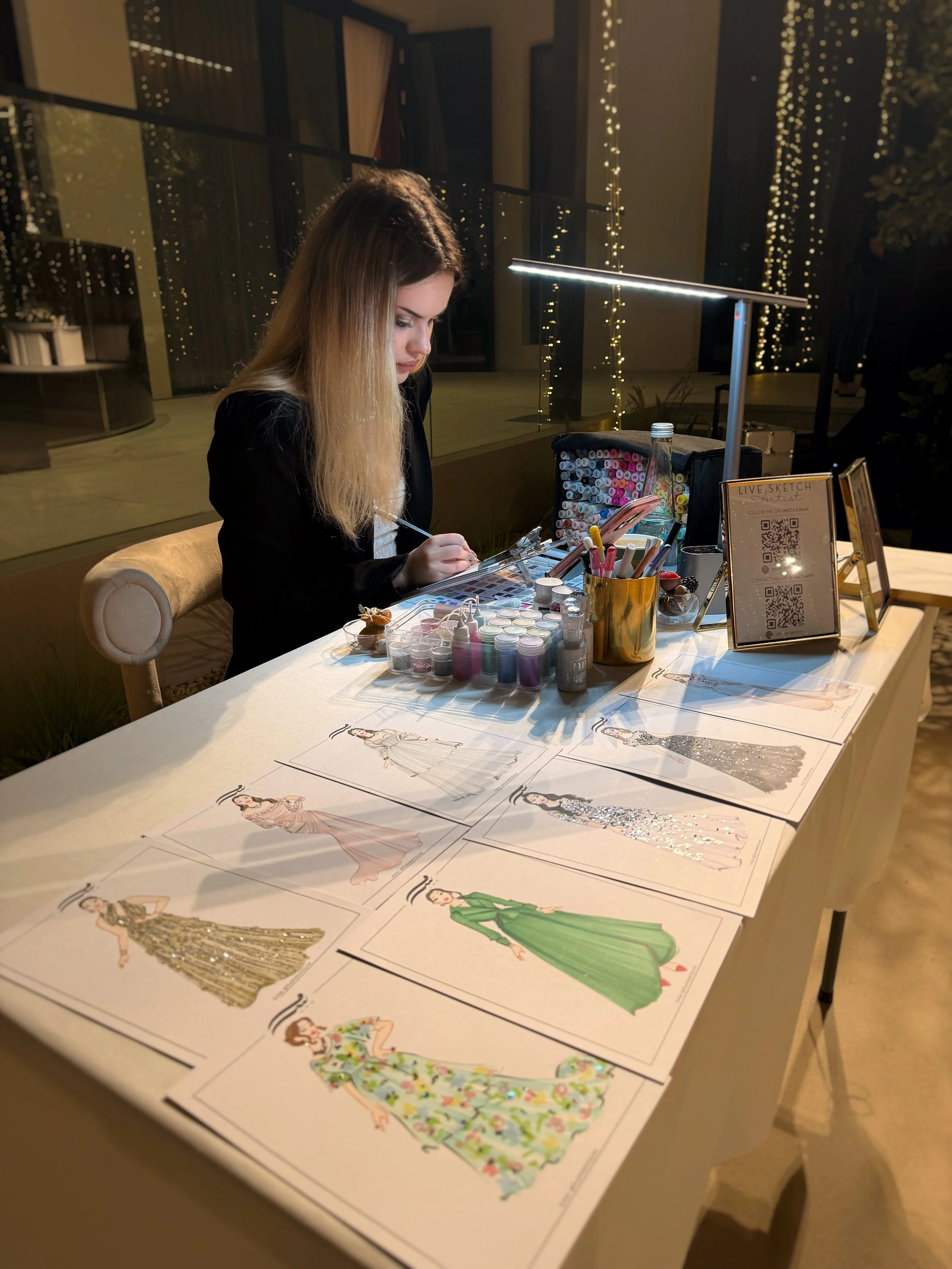 A live event illustrator sitting on luxury wedding