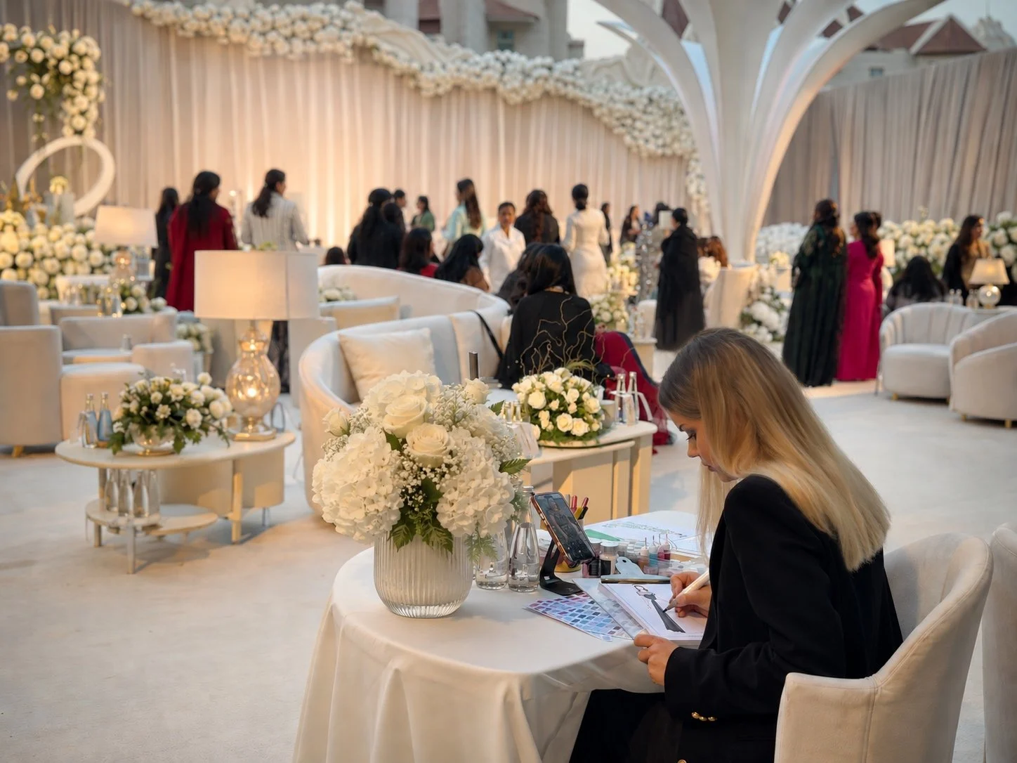 A female live illustrator is creating a portrait sketch during luxury wedding