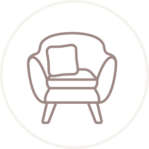 Icon of a cozy armchair with a pillow on it, representing therapy sessions.