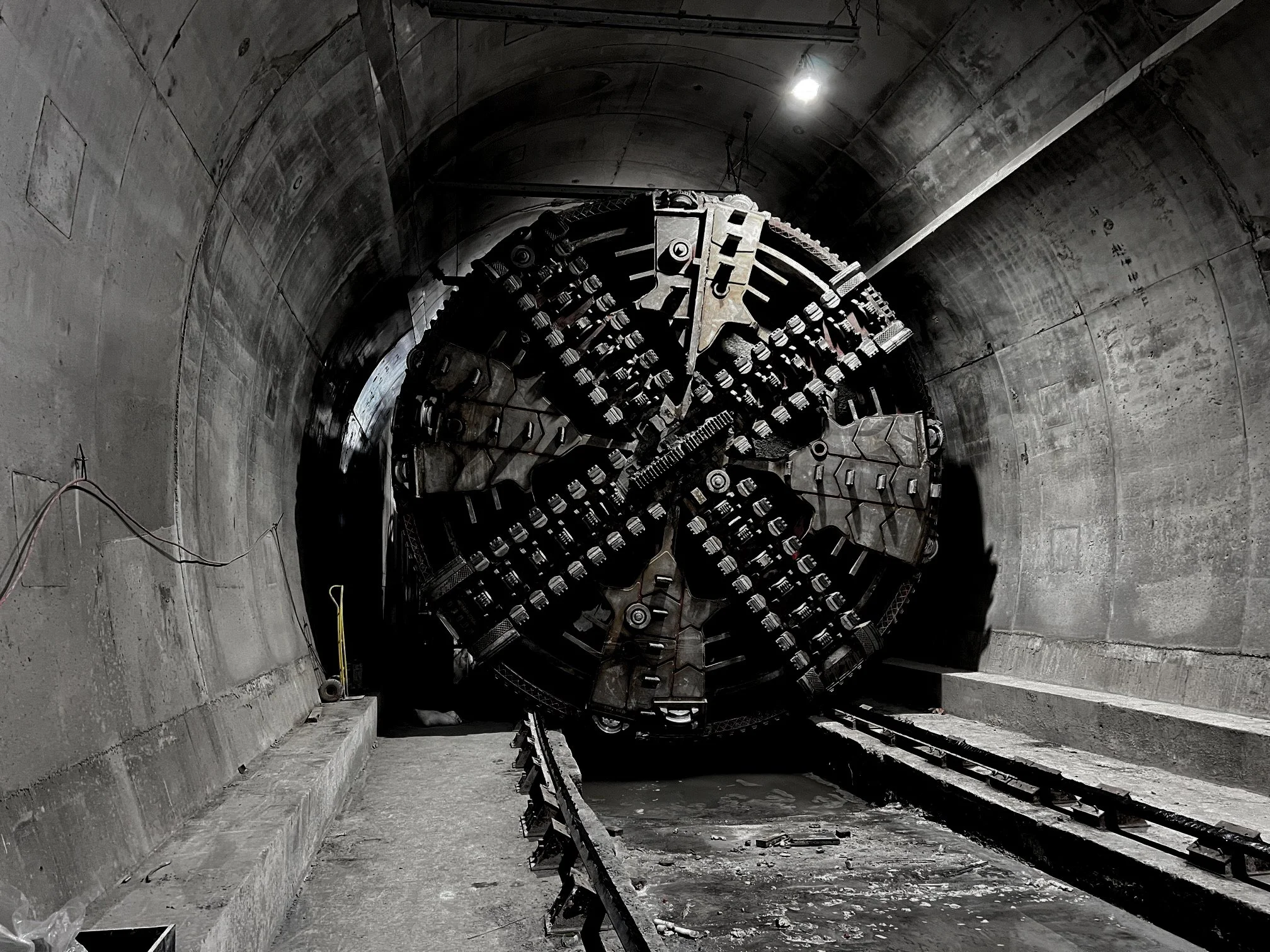 Professional image of a tunnel digging machine digging through a tunnel, with the words "made by uno - video and brand services in Doncaster" carved into the wall of the tunnel"