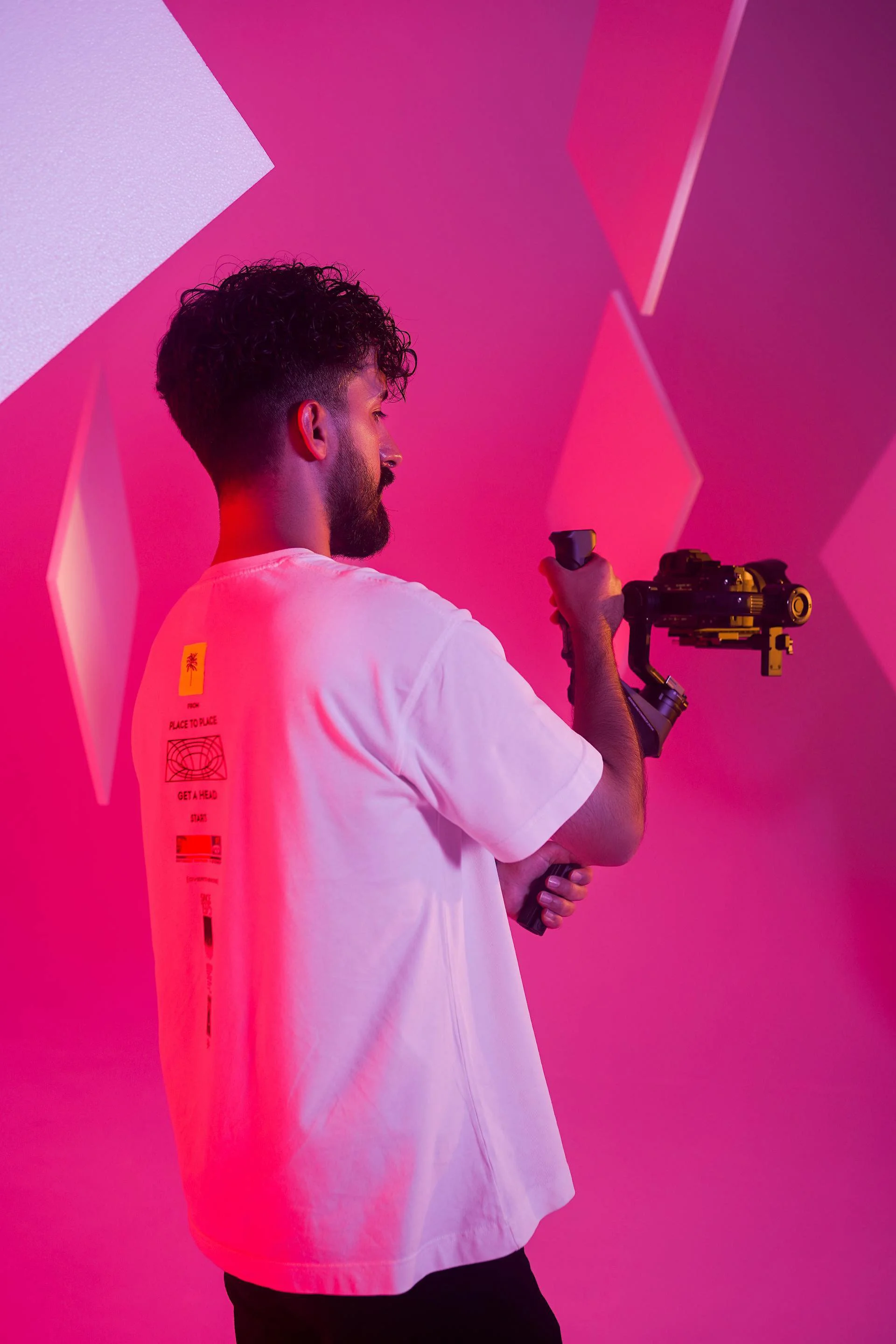 Image of a young man with professional video equipment, inlcuding DSLR & gimble, doing a professional video shoot in Manchester - with the words "Video services in doncaster, manchester, sheffield & leeds" overlayed on top