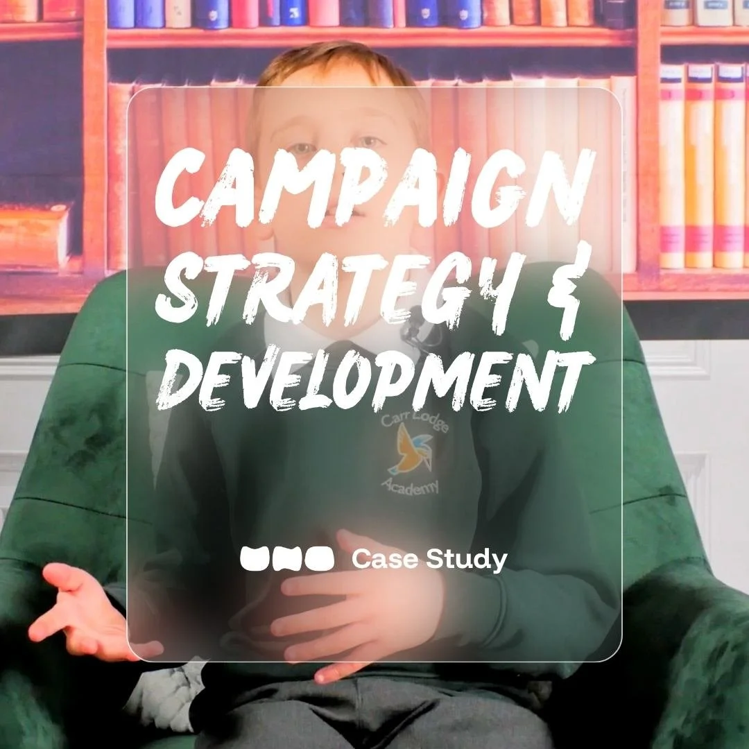Young boy sitting on a green chair with a background of bookshelves filled with colorful books. Text overlay reading 'Campaign Strategy & Development'