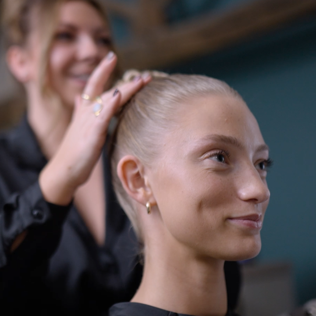 A woman with light hair getting her hair styled by a professional hair stylist in a salon in Doncaster