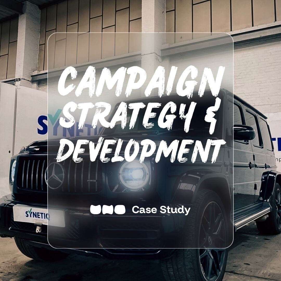 Black luxury Mercedes-Benz G-Wagon parked indoors with a partially visible Synetic logo on the wall behind it, overlaid with white text reading 'Brand Strategy & Campaign Development'