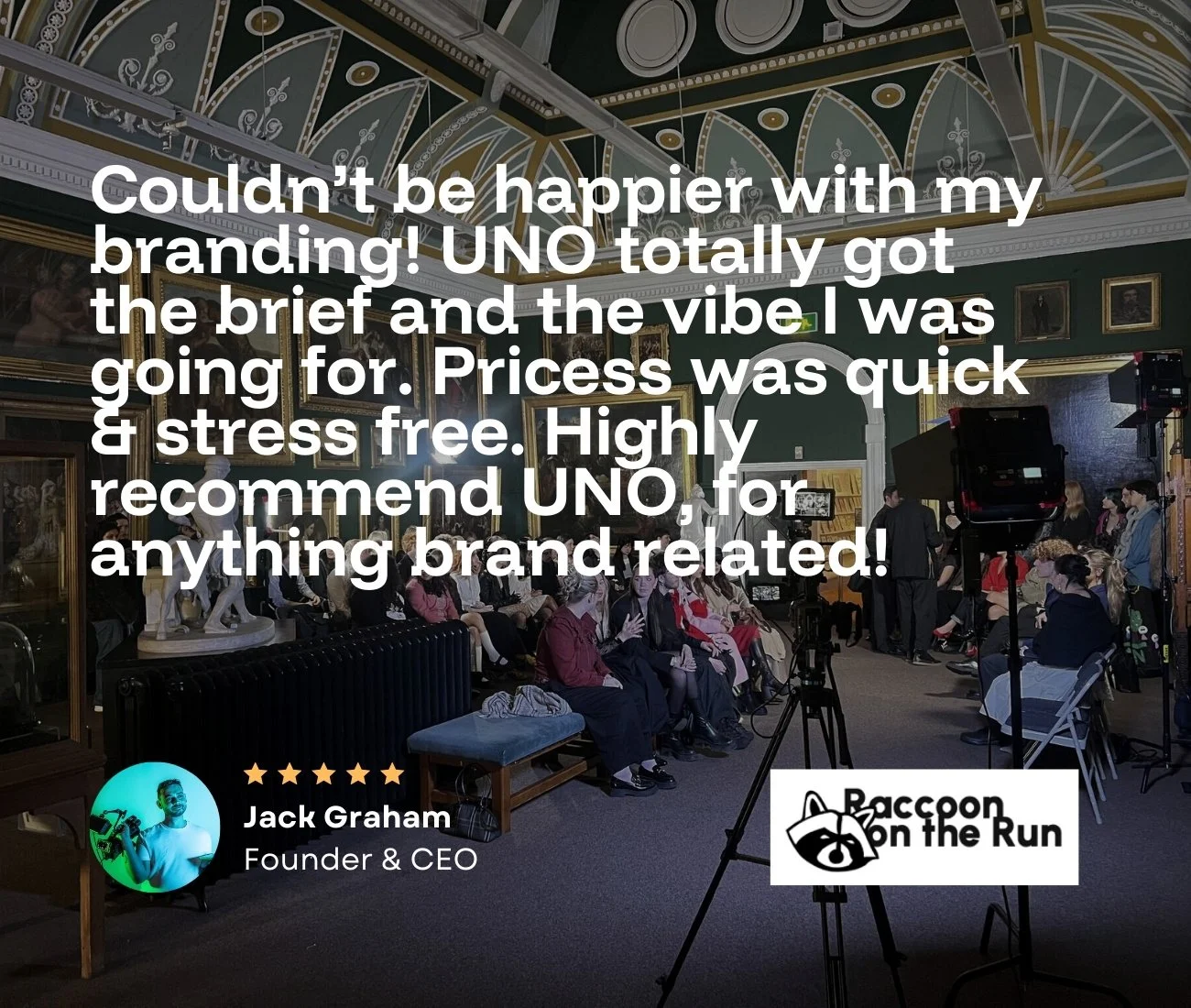 A conference room in Doncaster with an audience seated, with professsional DSLR cameras and lighting setup, with a speech being filmed by professional videographers wearing tshirts that read "video services"