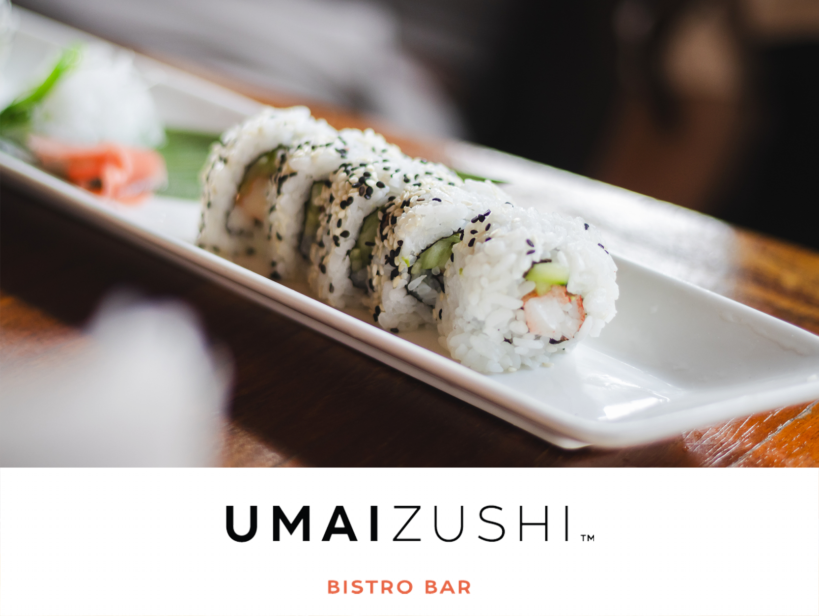 Image of California roll sushi on a white plate, on dining table