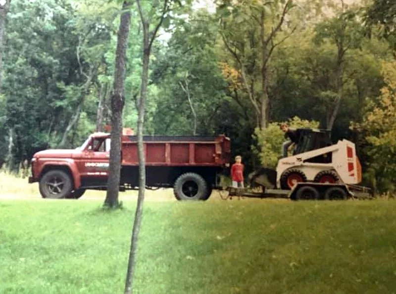 Early Flygare Excavating equipment with dump truck and skid steer in Annandale MN