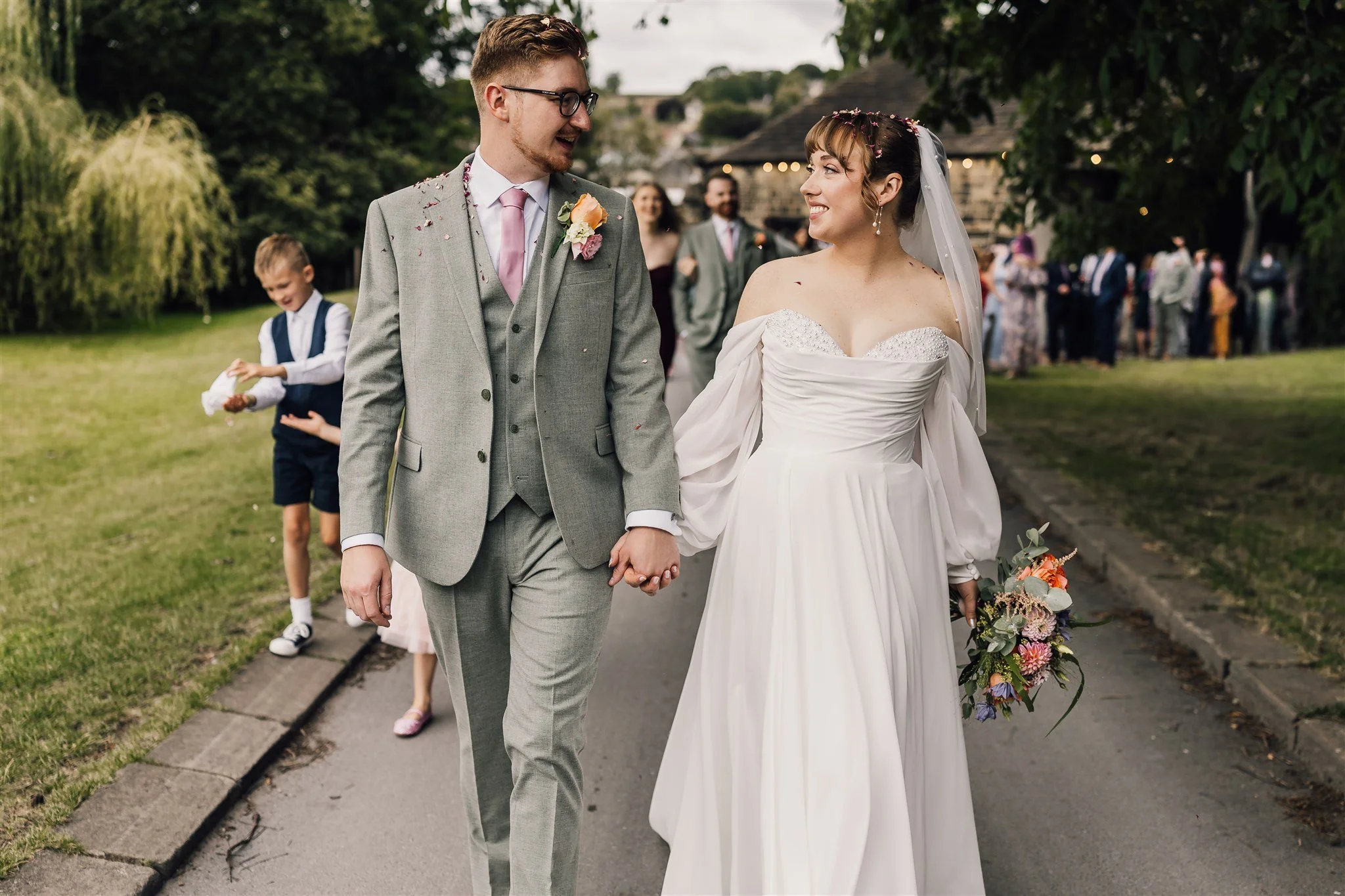 Bride and groom walking together after ceremony at East Riddlesden Hall wedding venue