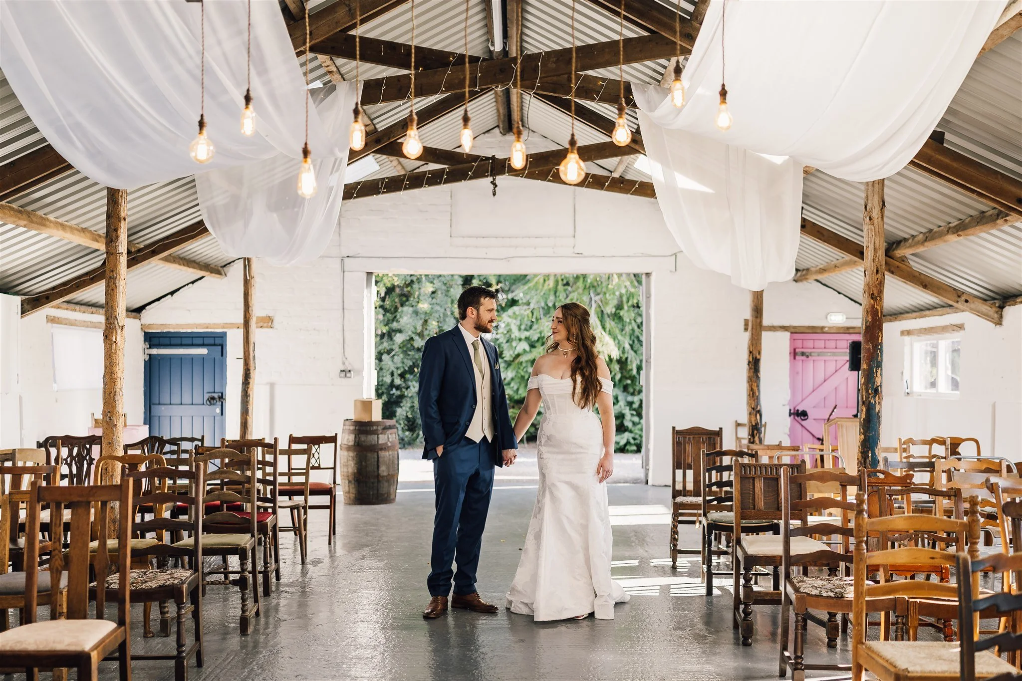 Bride and groom posing inside the piggery white Syke fields