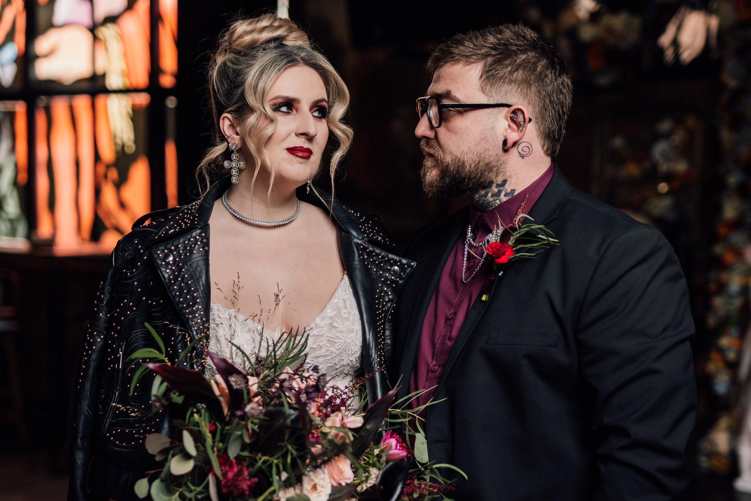 Alternative wedding couple portrait with dramatic bouquet and dark romantic styling