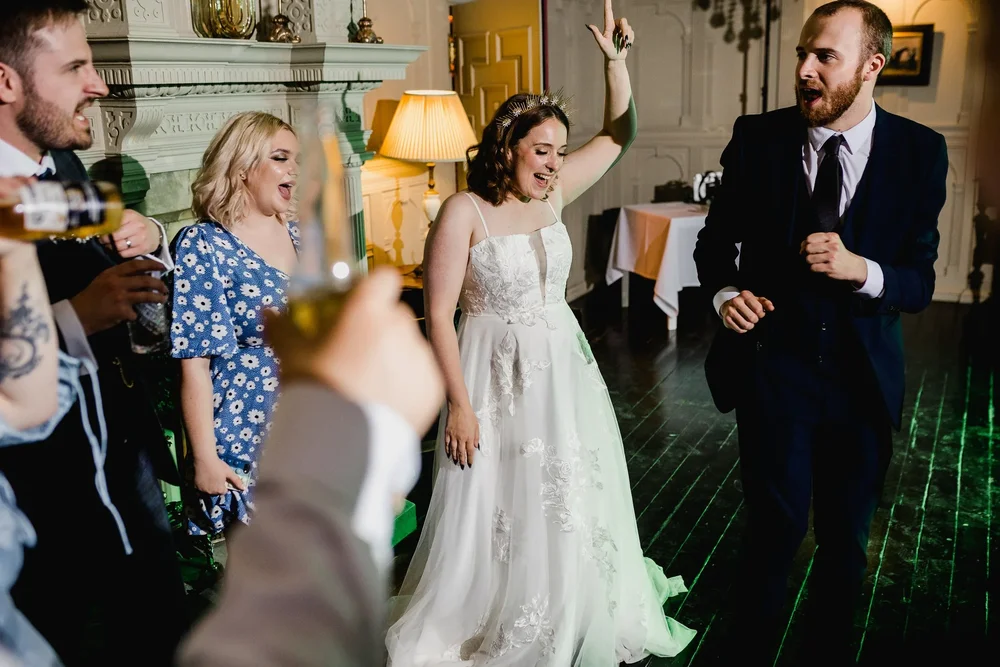 Katie and adult wedding guests enjoying the evening entertainment at Highfield House