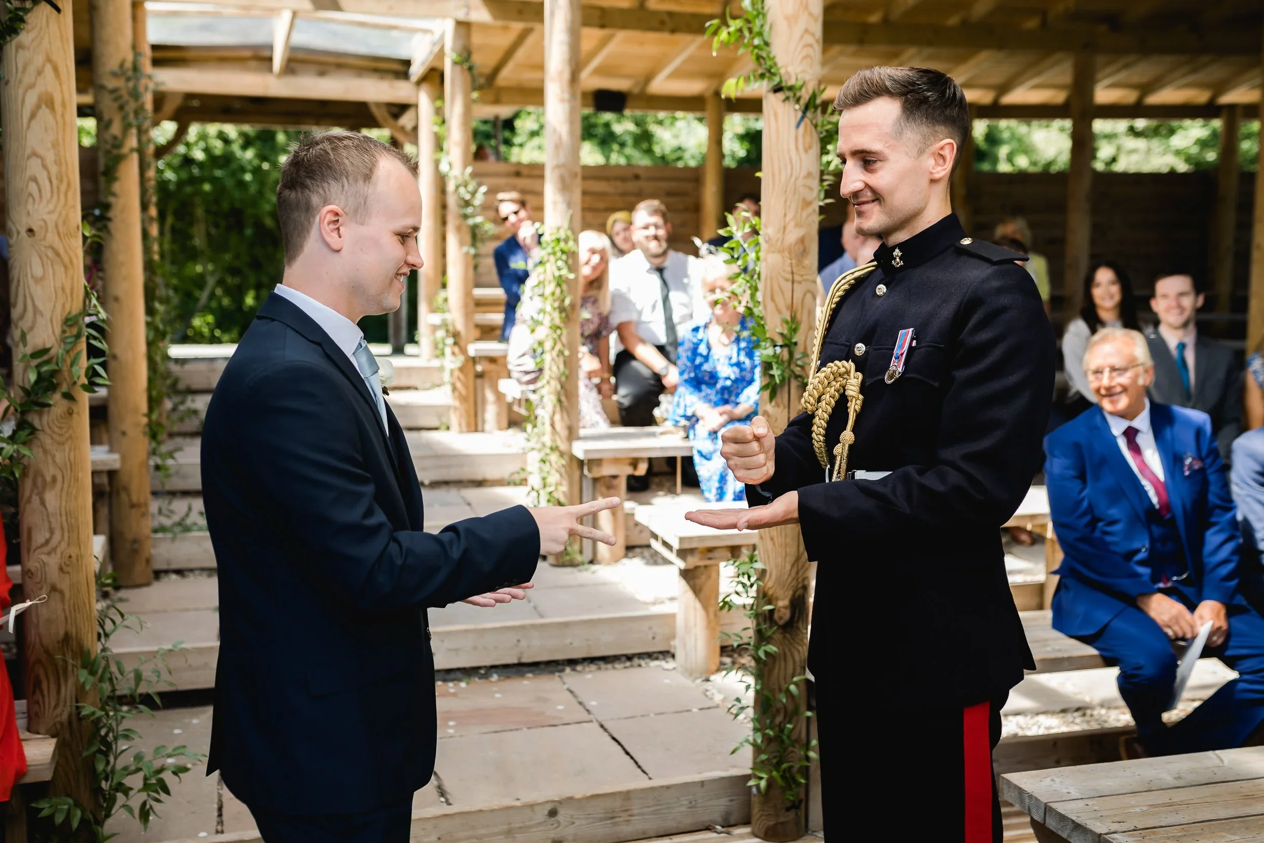 Fun rock paper scissors moment during a same sex wedding ceremony at Oaklands Grand Lodge lakeside pavilion.