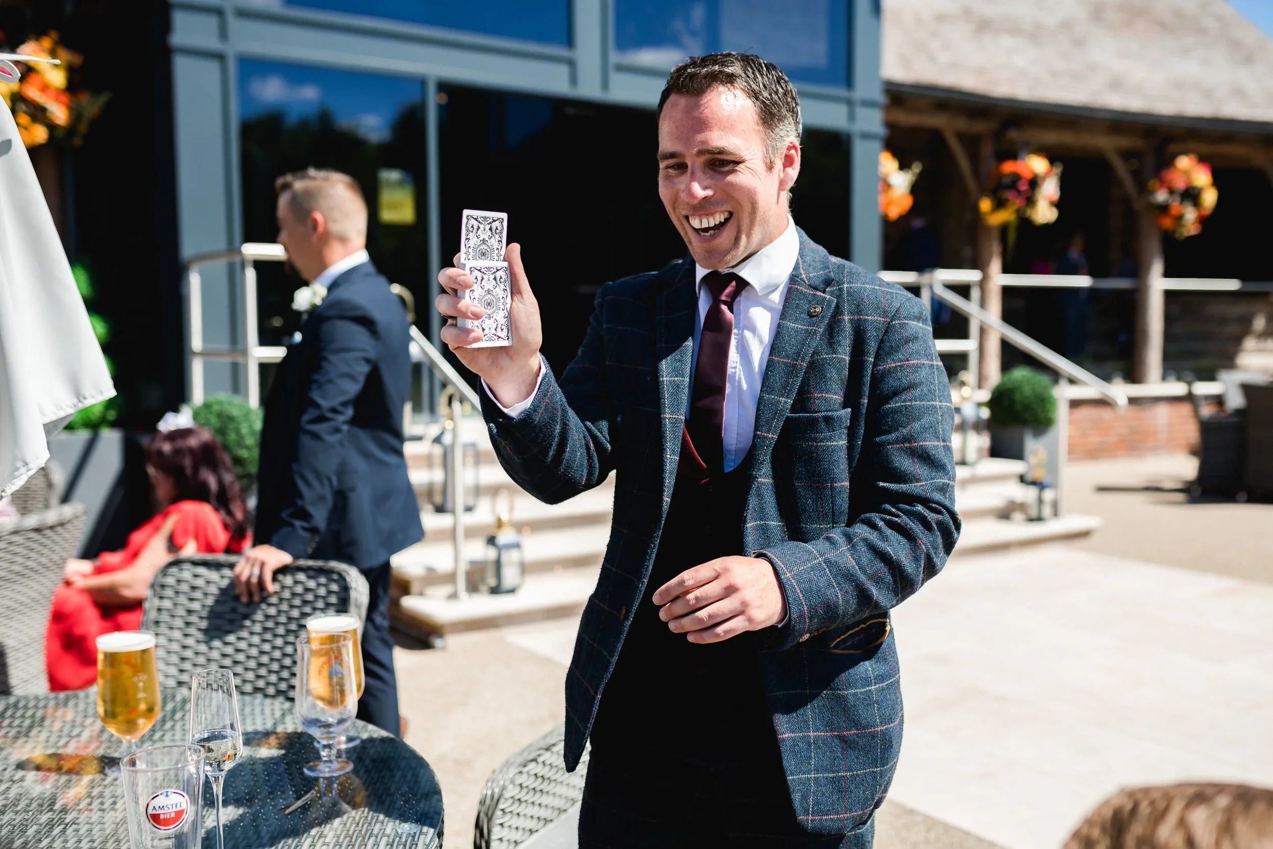 Magician Rich Reynolds performing close up magic for guests during the drinks reception at Oaklands Grand Lodge wedding venue in Driffield, East Yorkshire