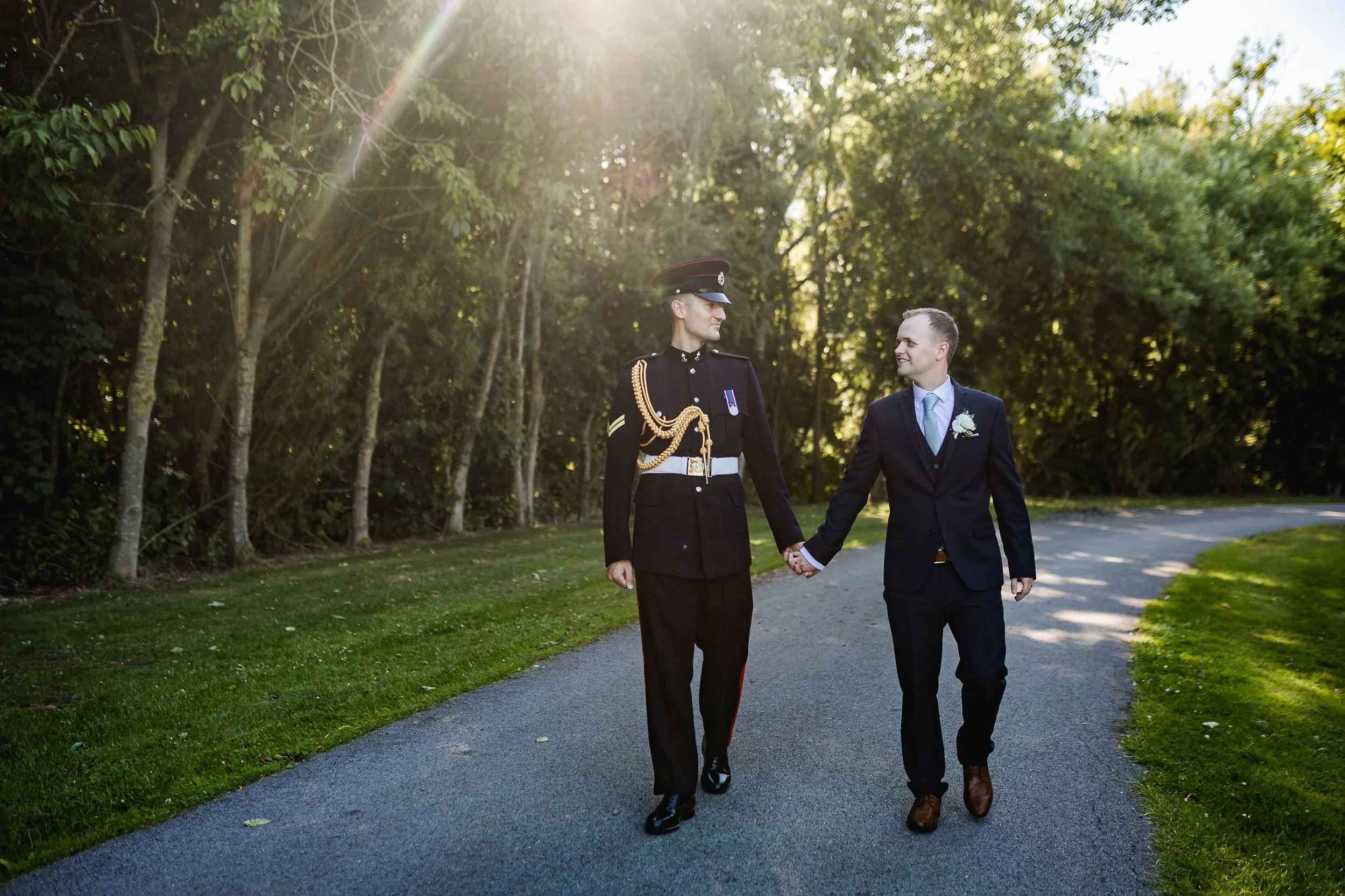 Grooms walking together during their wedding day at Oaklands Grand Lodge in East Yorkshire.