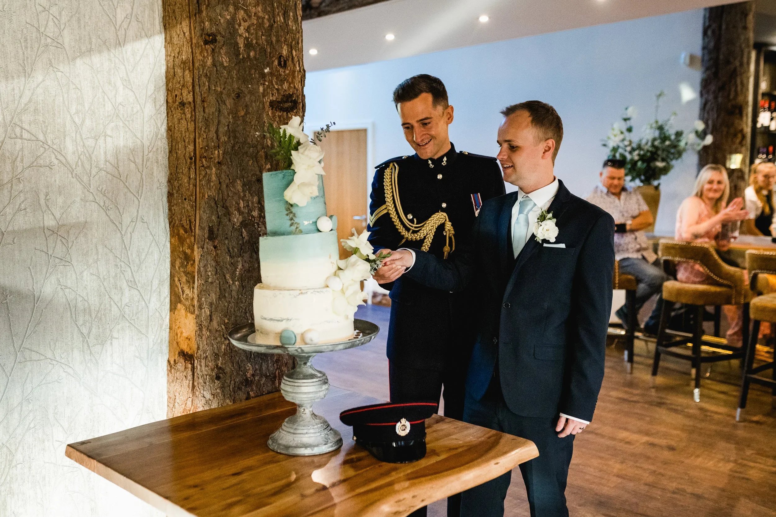 Same sex couple cutting their wedding cake at Oaklands Grand Lodge wedding reception in Driffield.