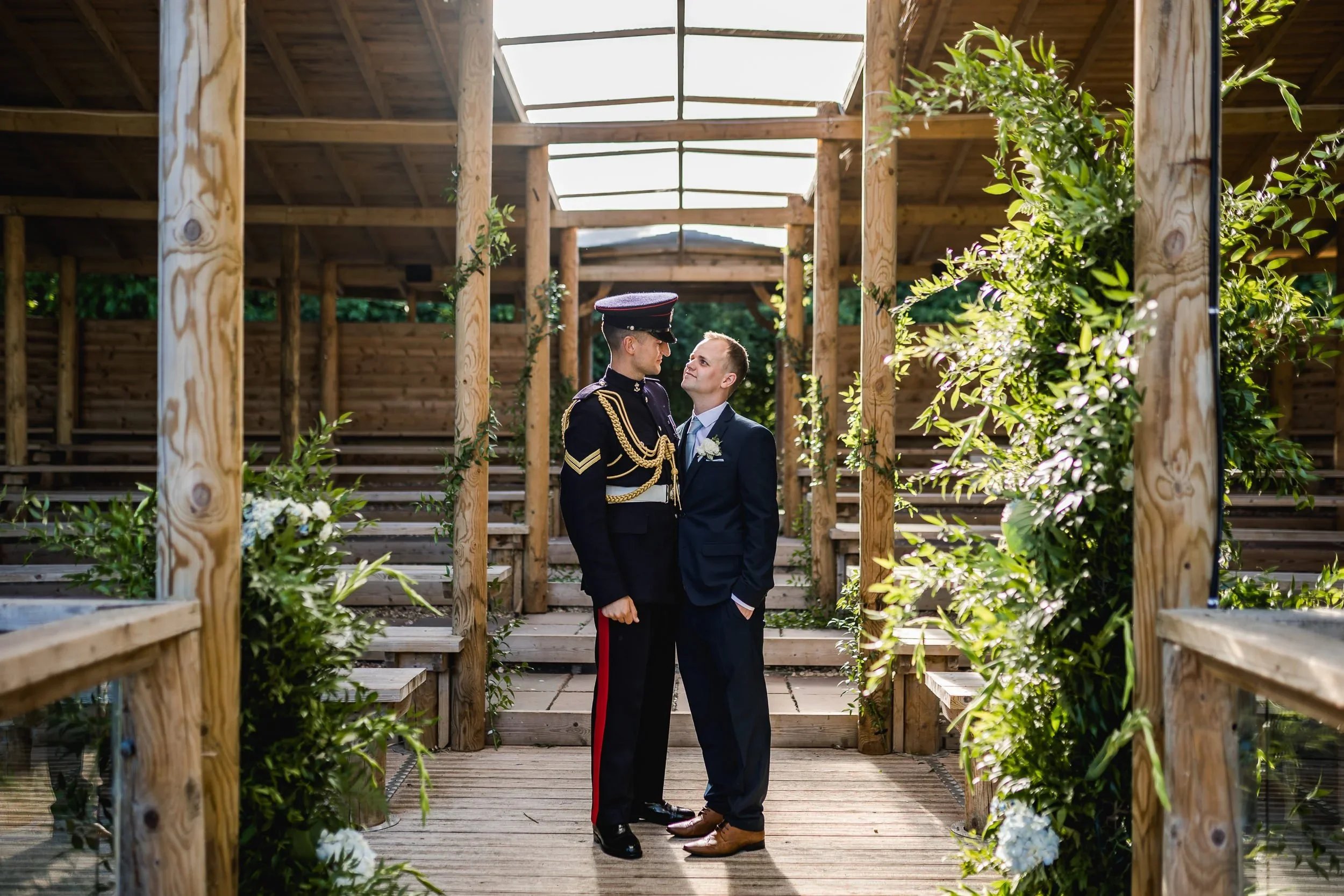 Same sex couple standing in the lakeside pavilion during their wedding at Oaklands Grand Lodge in Driffield, East Yorkshire.