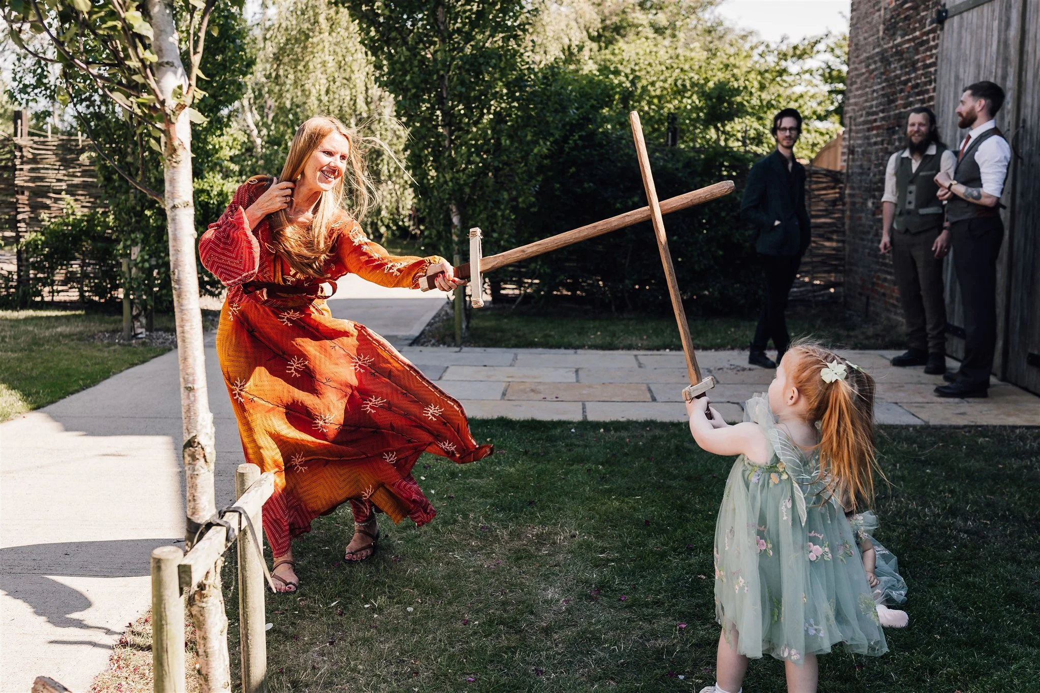 Guests having a sword fight with wooden swords