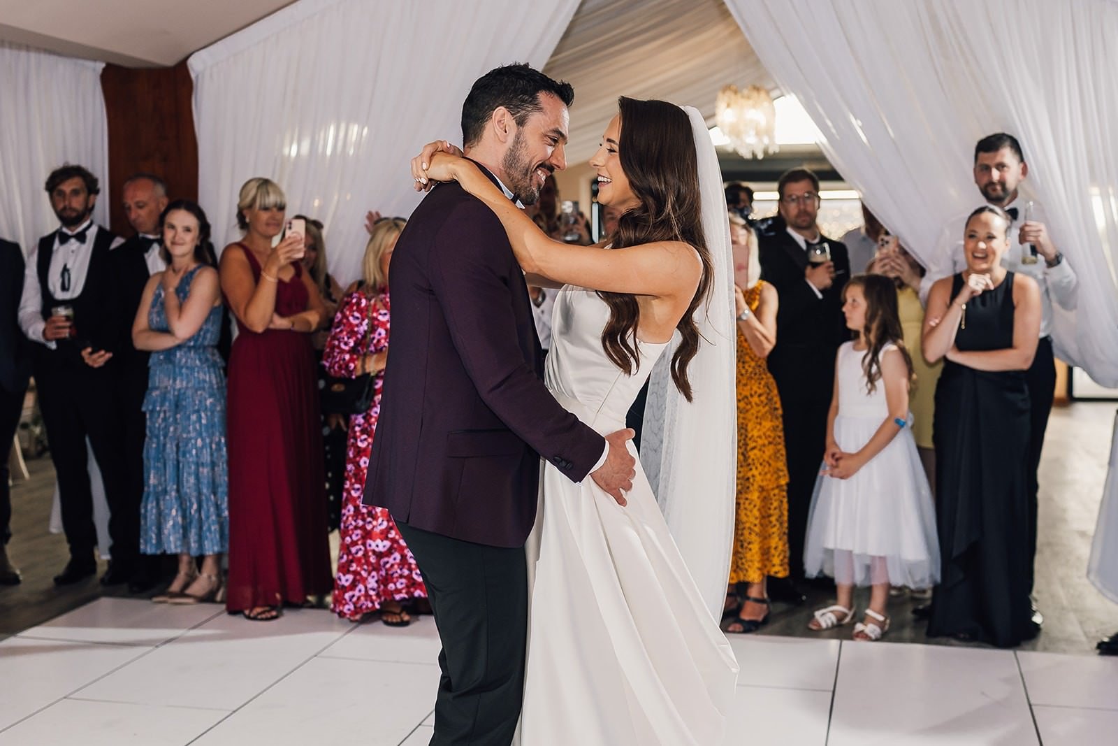 Becky and Brad embracing during their first dance at The Barn at Willerby