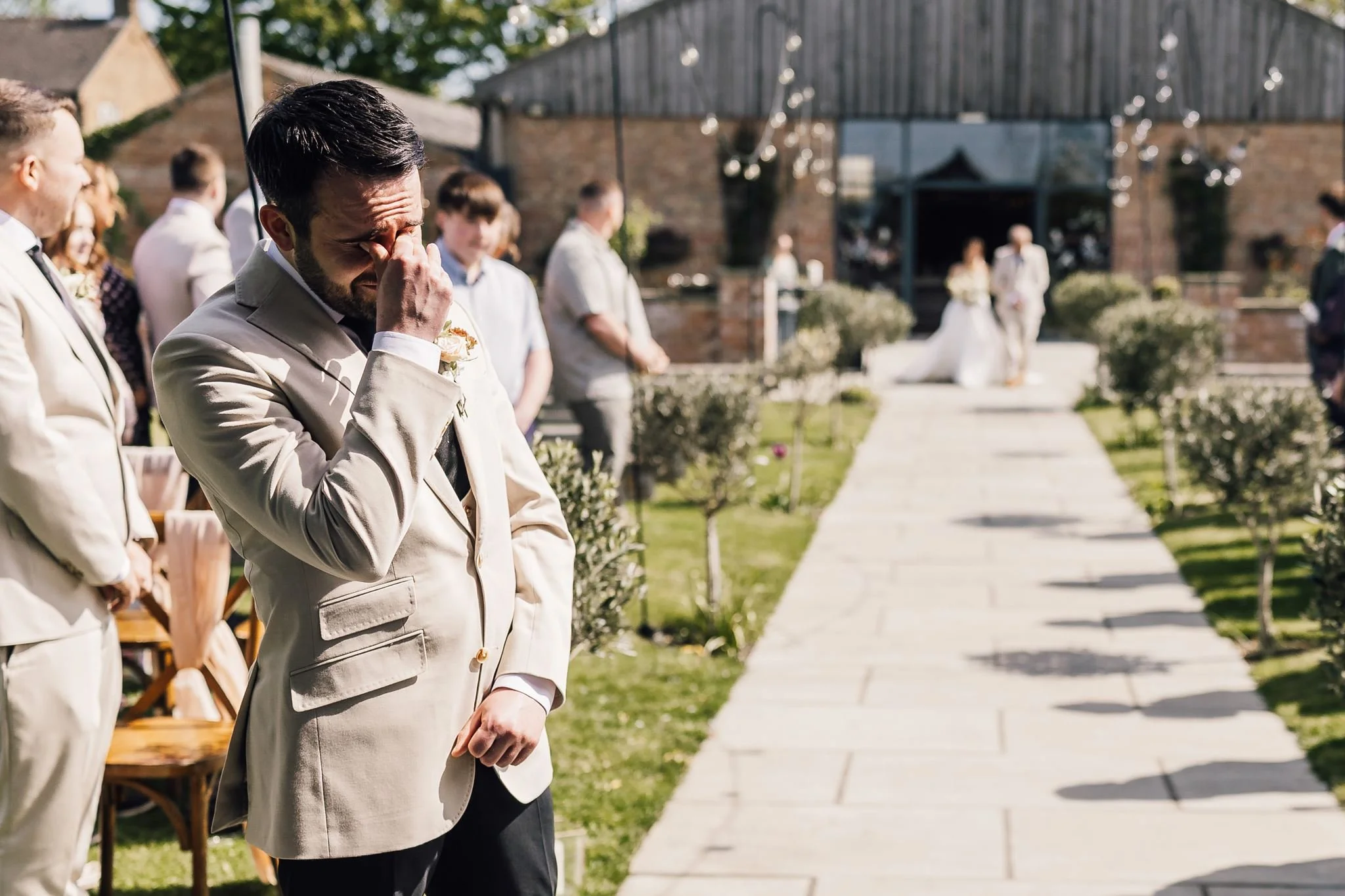 Harry waiting beside the outdoor wedding aisle