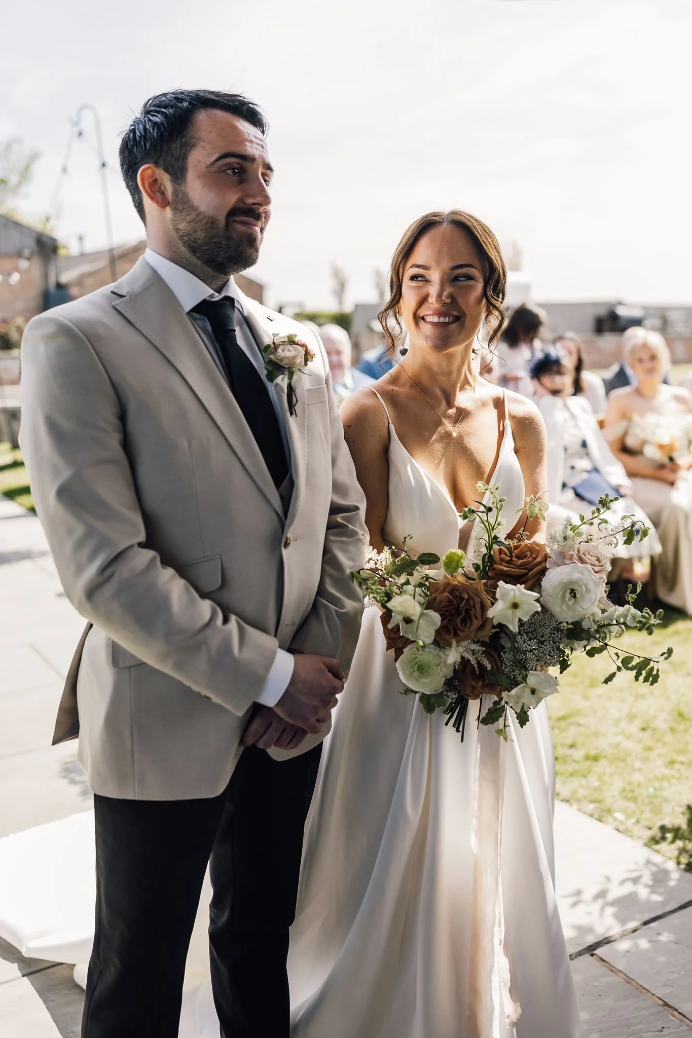 Rachel and Harry standing together during their outdoor wedding ceremony
