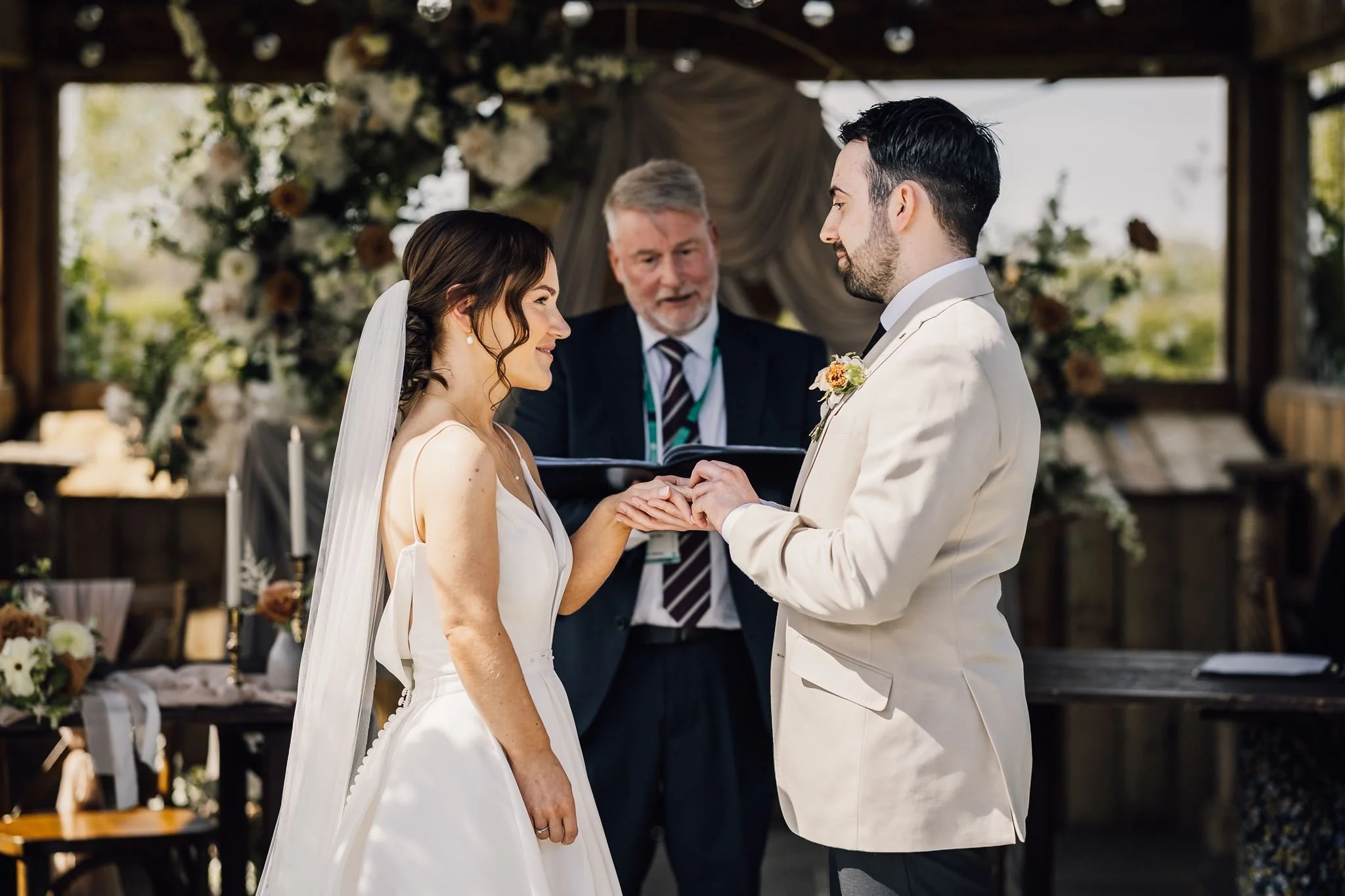 Harry placing a ring on Rachel’s finger during the wedding ceremony