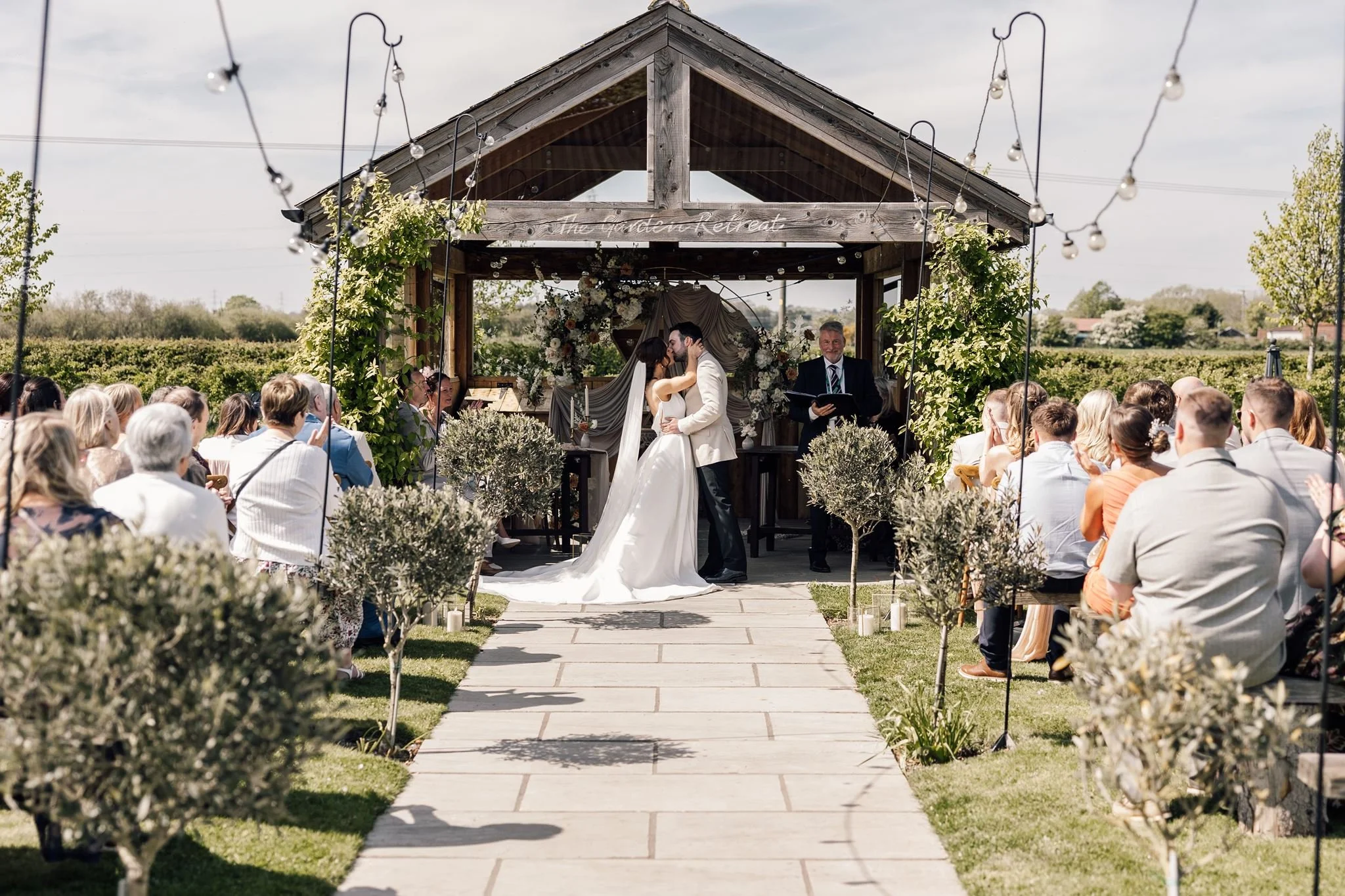 The garden wedding aisle leading to Rachel and Harry’s ceremony