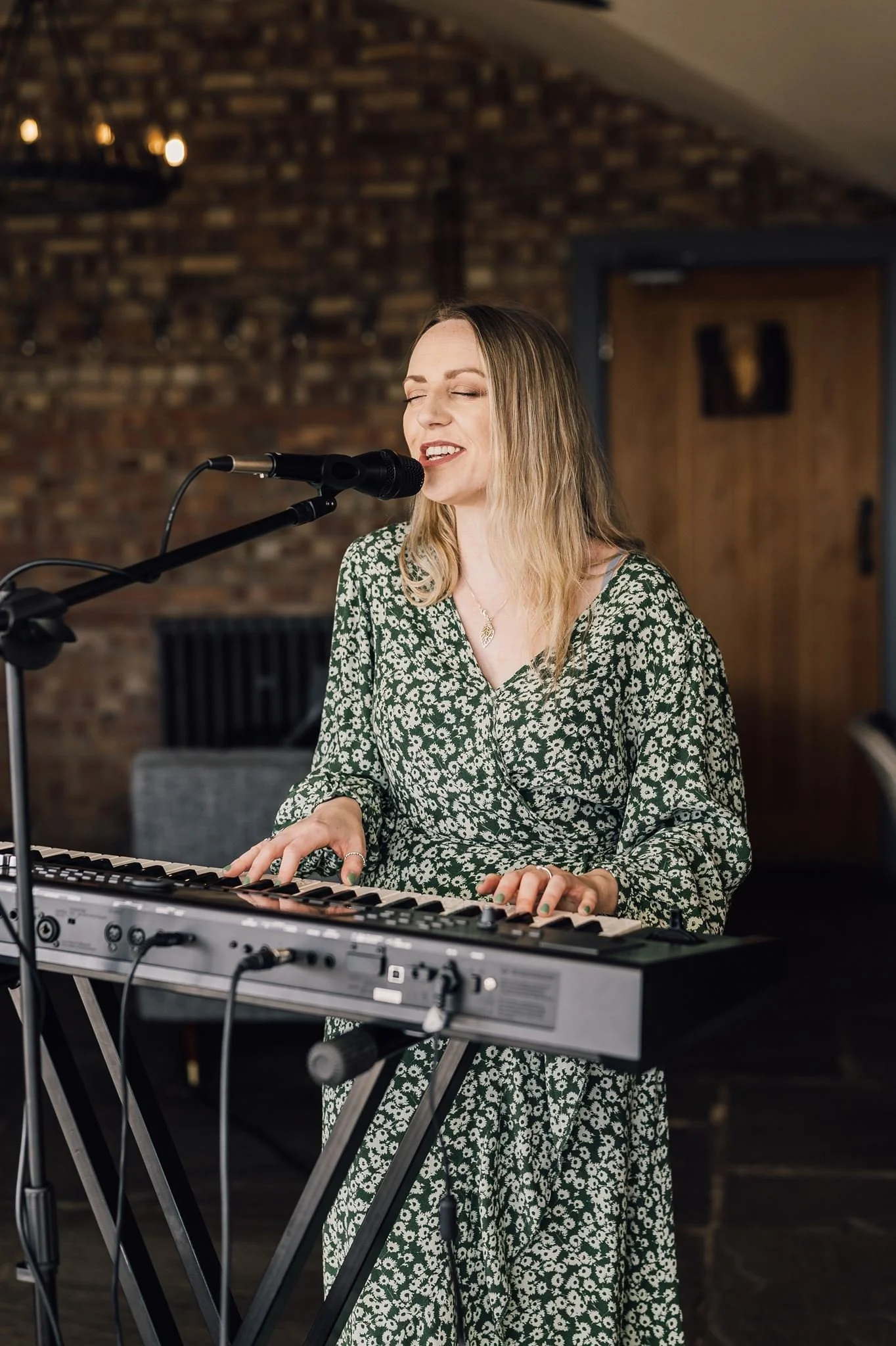 A singer and keyboard player performing inside The Beverley Barn
