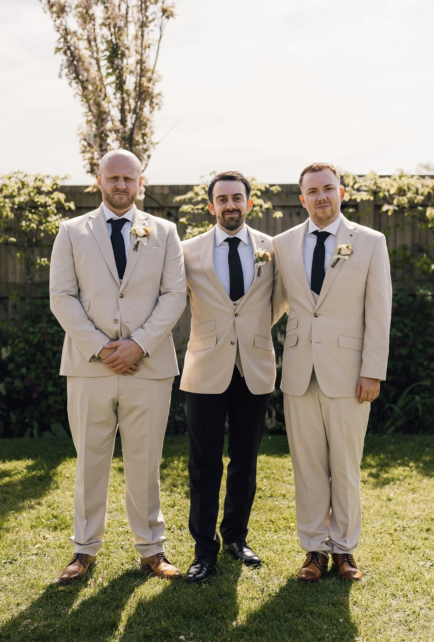 Harry and his groomsmen standing together on the lawn