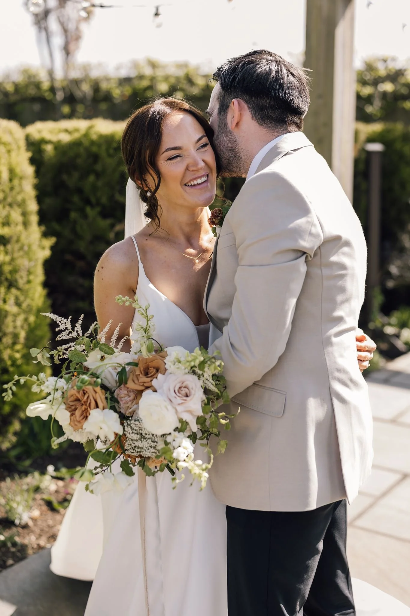 Harry kissing Rachel’s forehead during a relaxed garden portrait